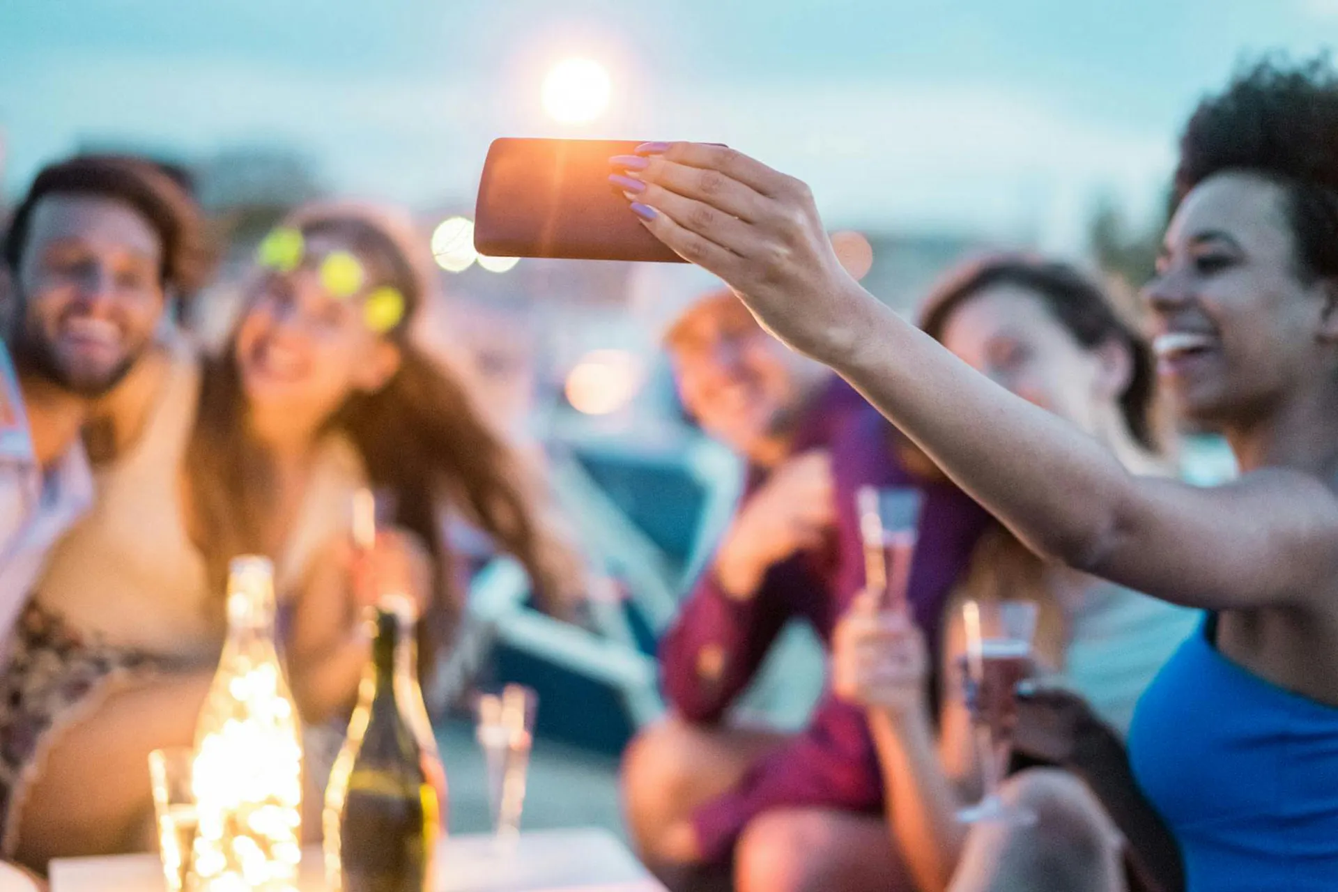Photo of women at an outdoor party taking a selfie