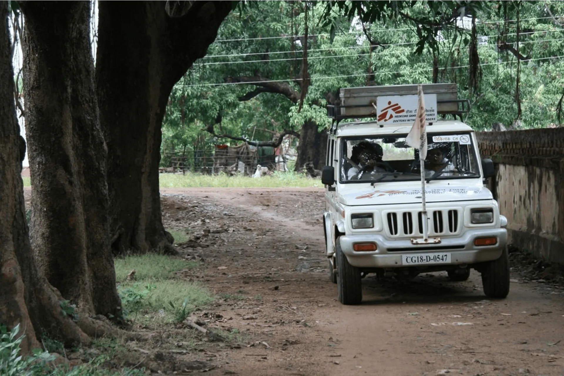 A jeep driving down a dirt track