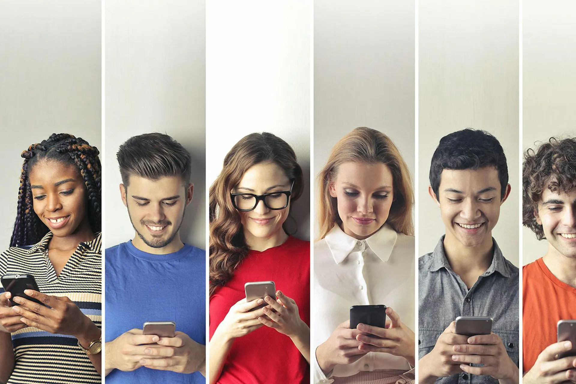 Photo of different people next to each other with their smartphones in hand