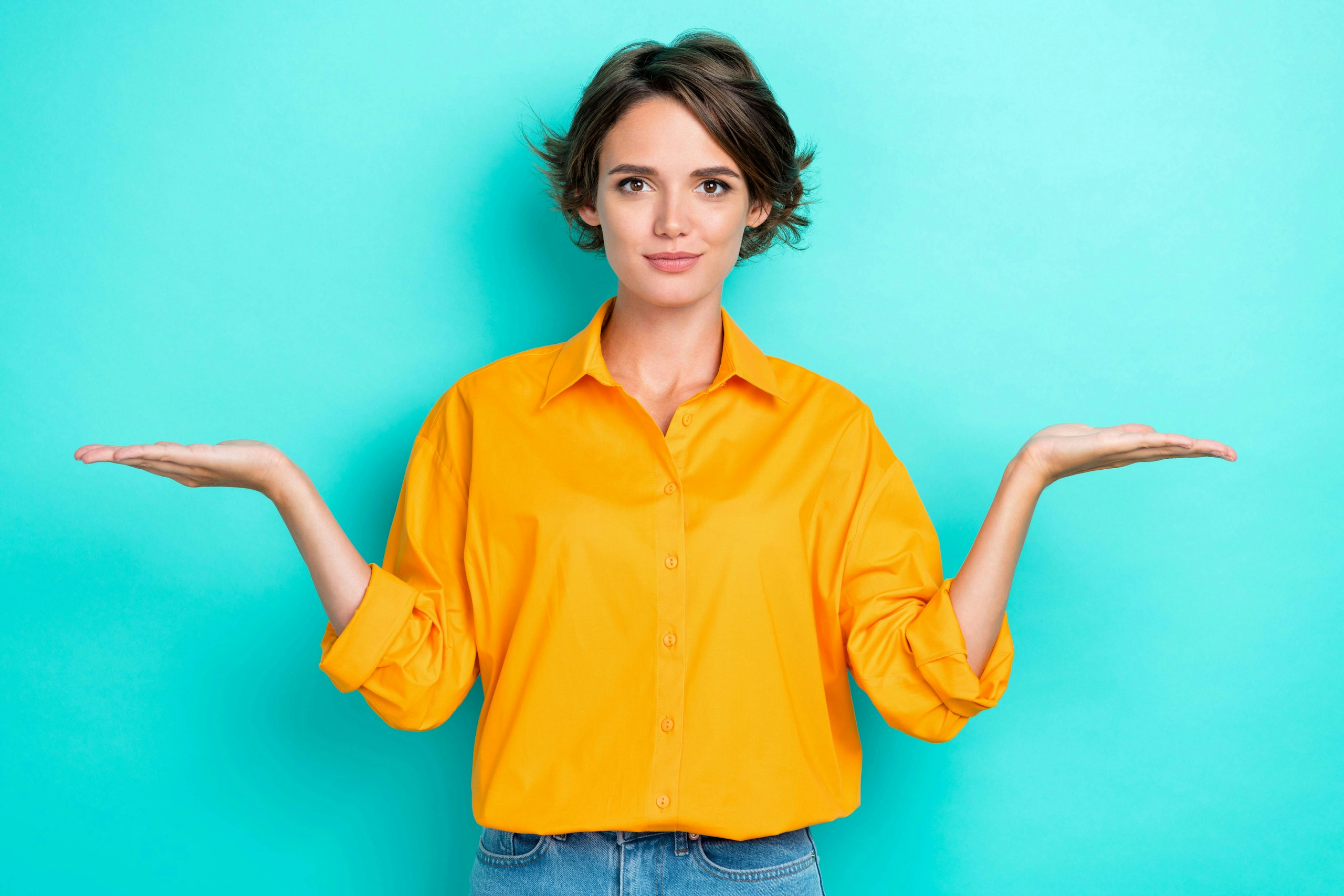 Woman standing in front of a teal background