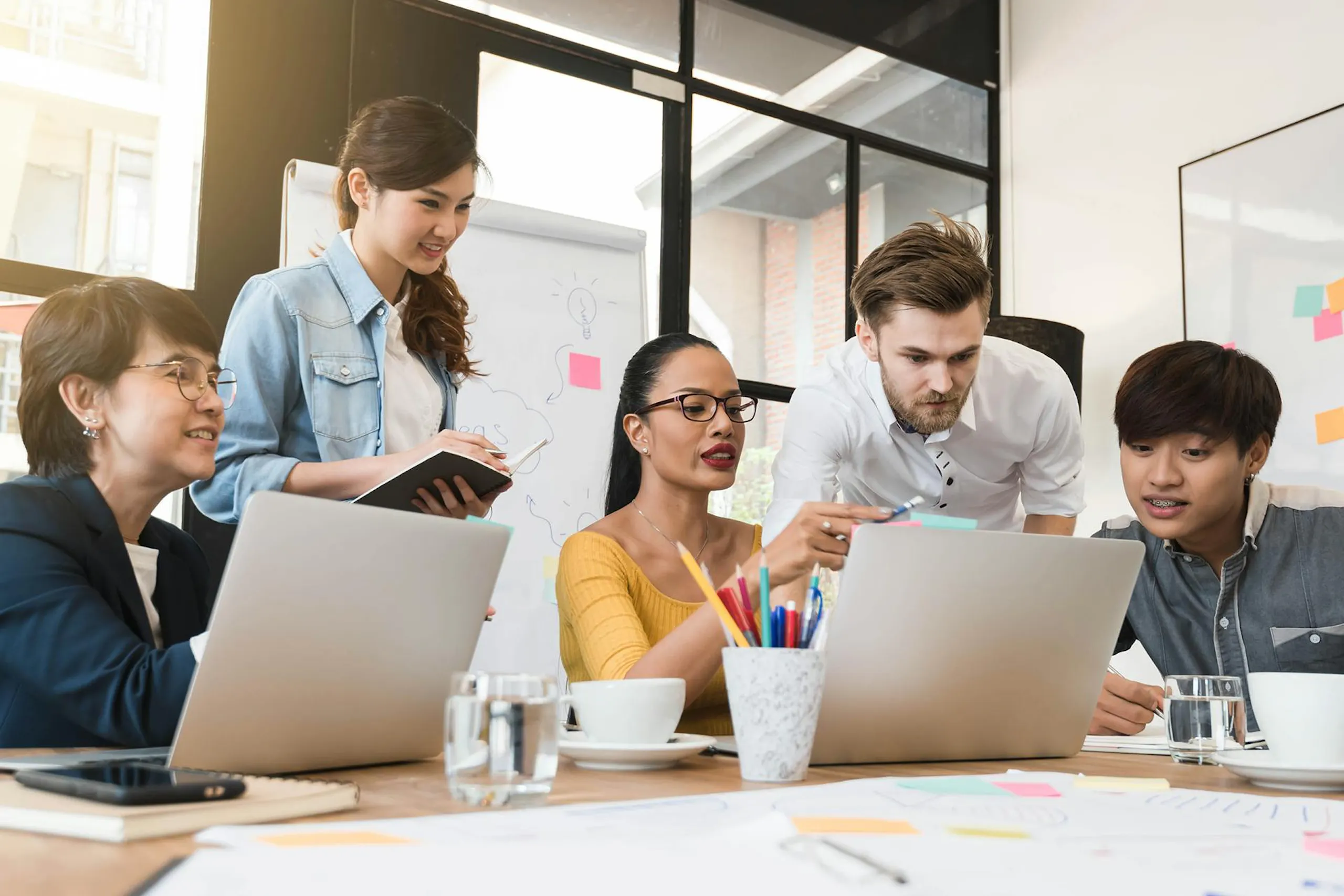 Group of people working around a table 