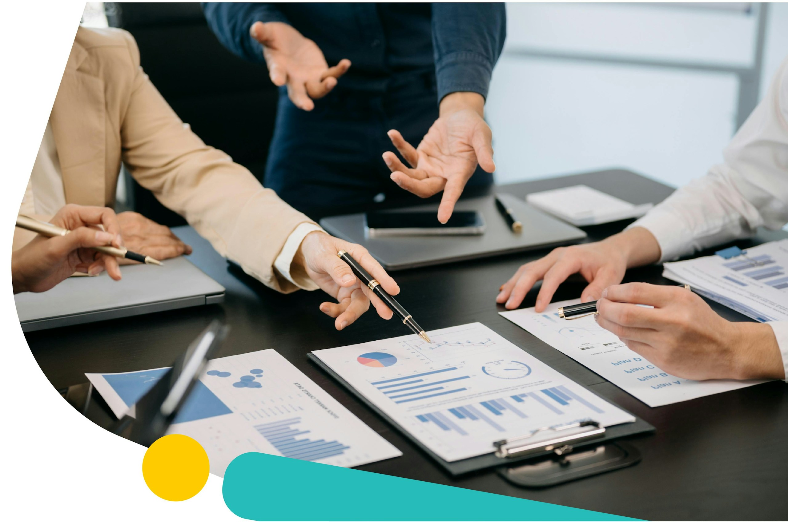 A group of three people in a meeting looking at several different graphs. Social Listening for Benchmarking Guide