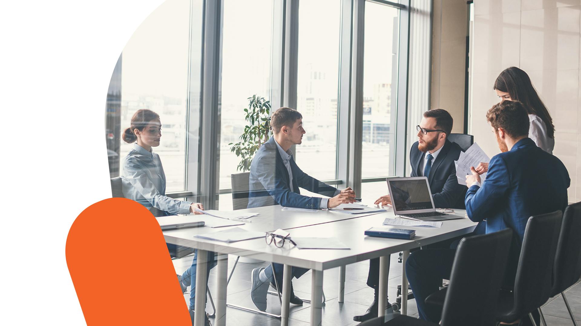 A photo of a group of business people in a meeting room. 