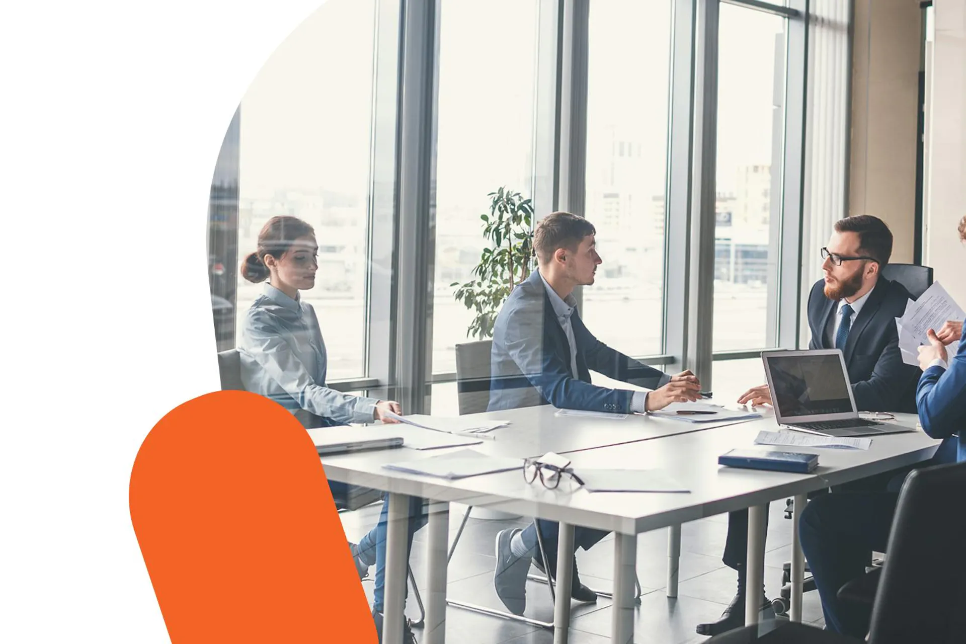 A photo of a group of business people in a meeting room.