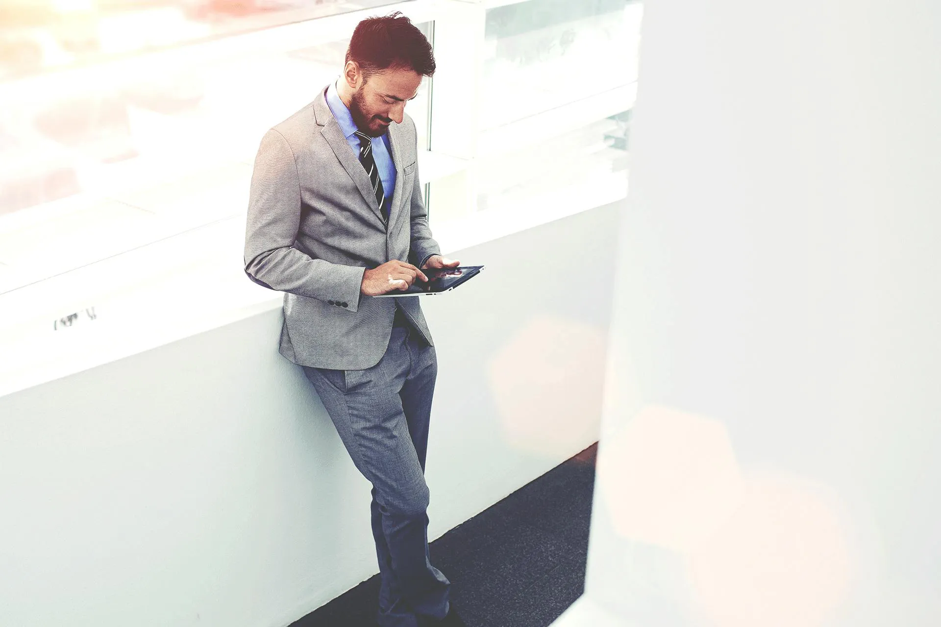 A man in a suit on an ipad