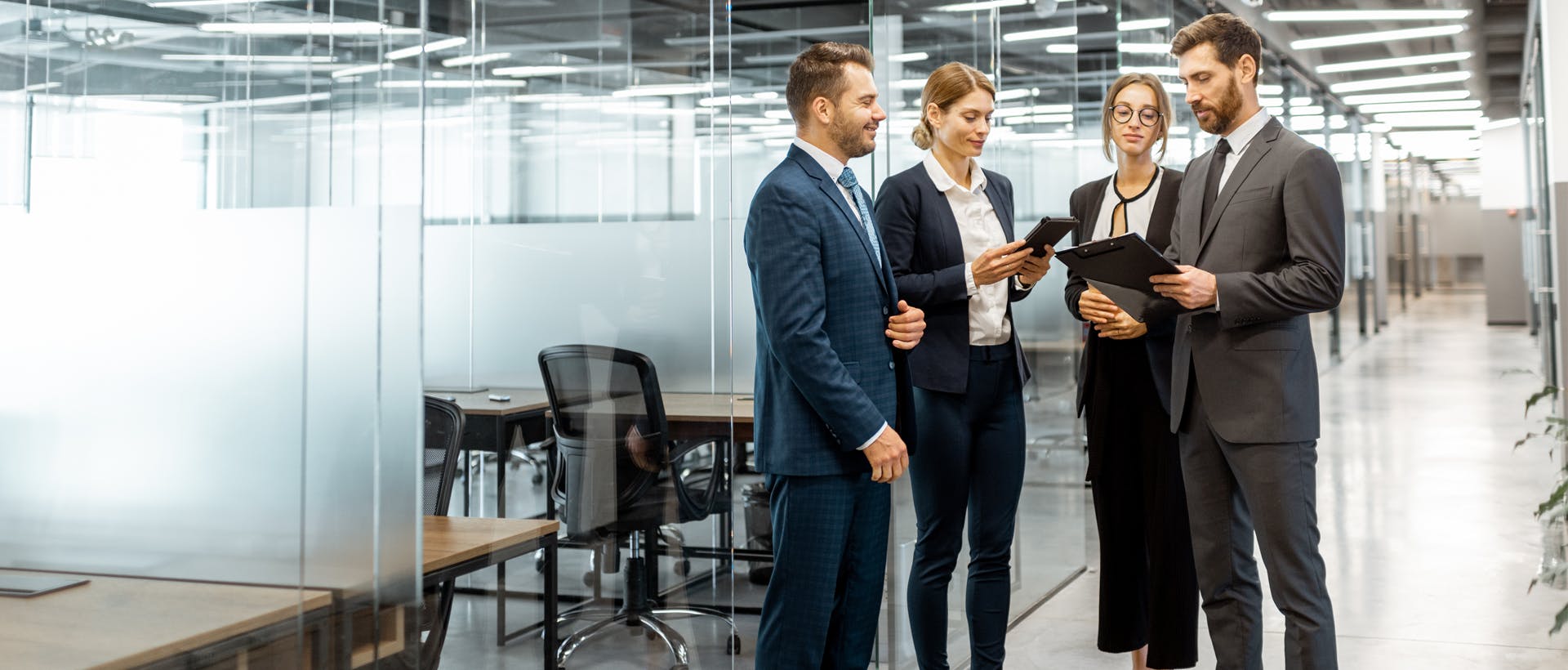 Group of people looking at a clip board in an office