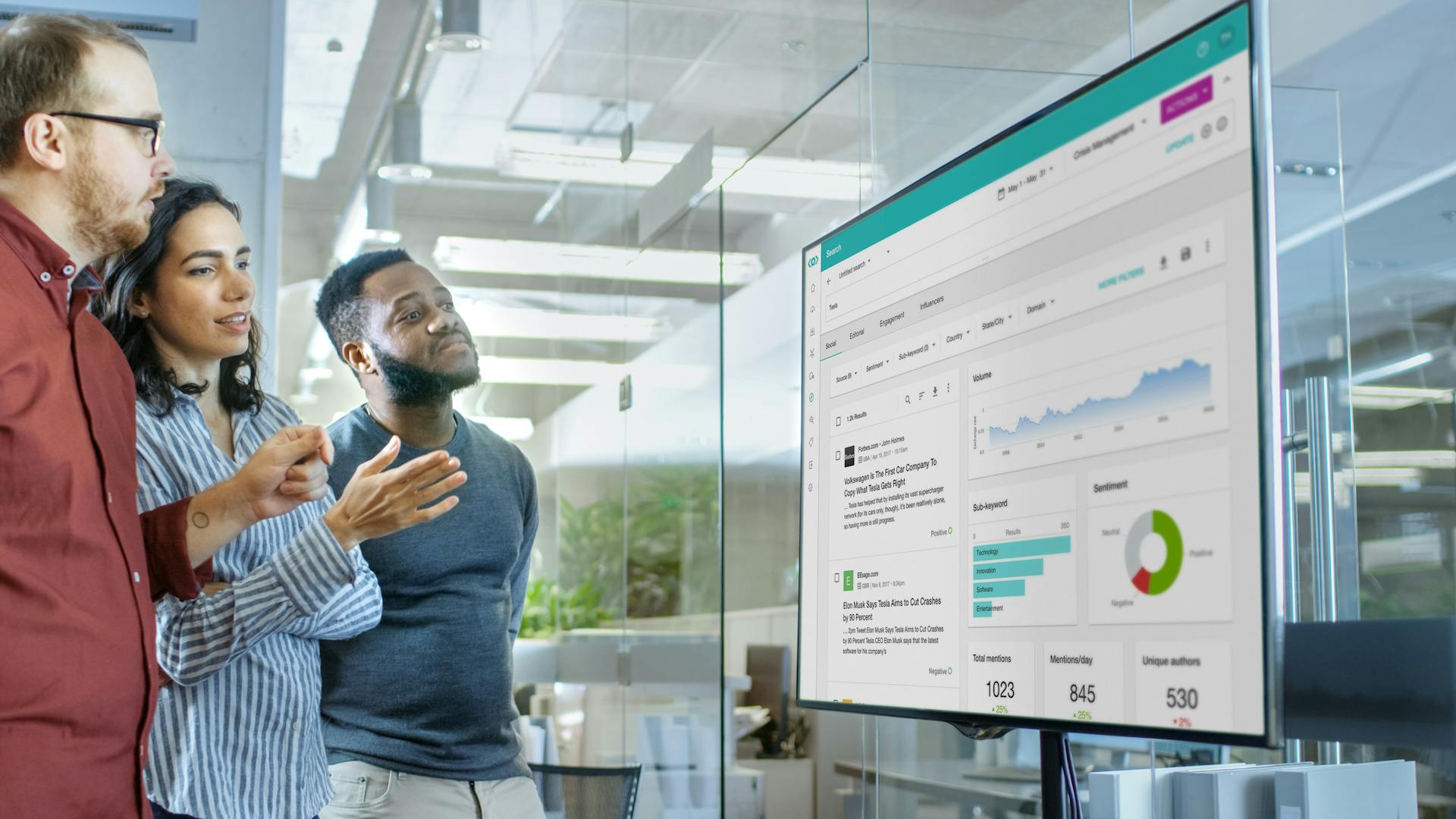 people discussing in front of big screen of graph and data