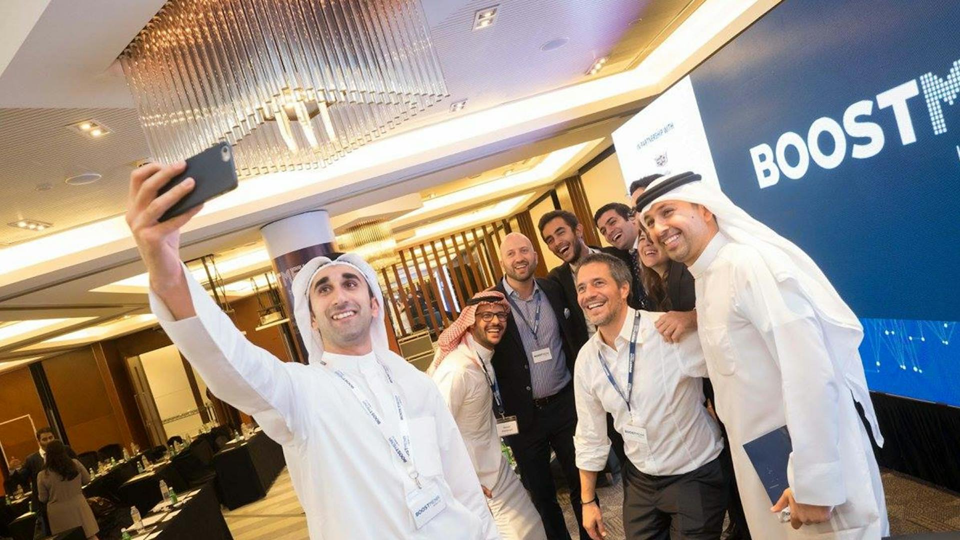 Photo of some business people in the middle east taking a group selfie