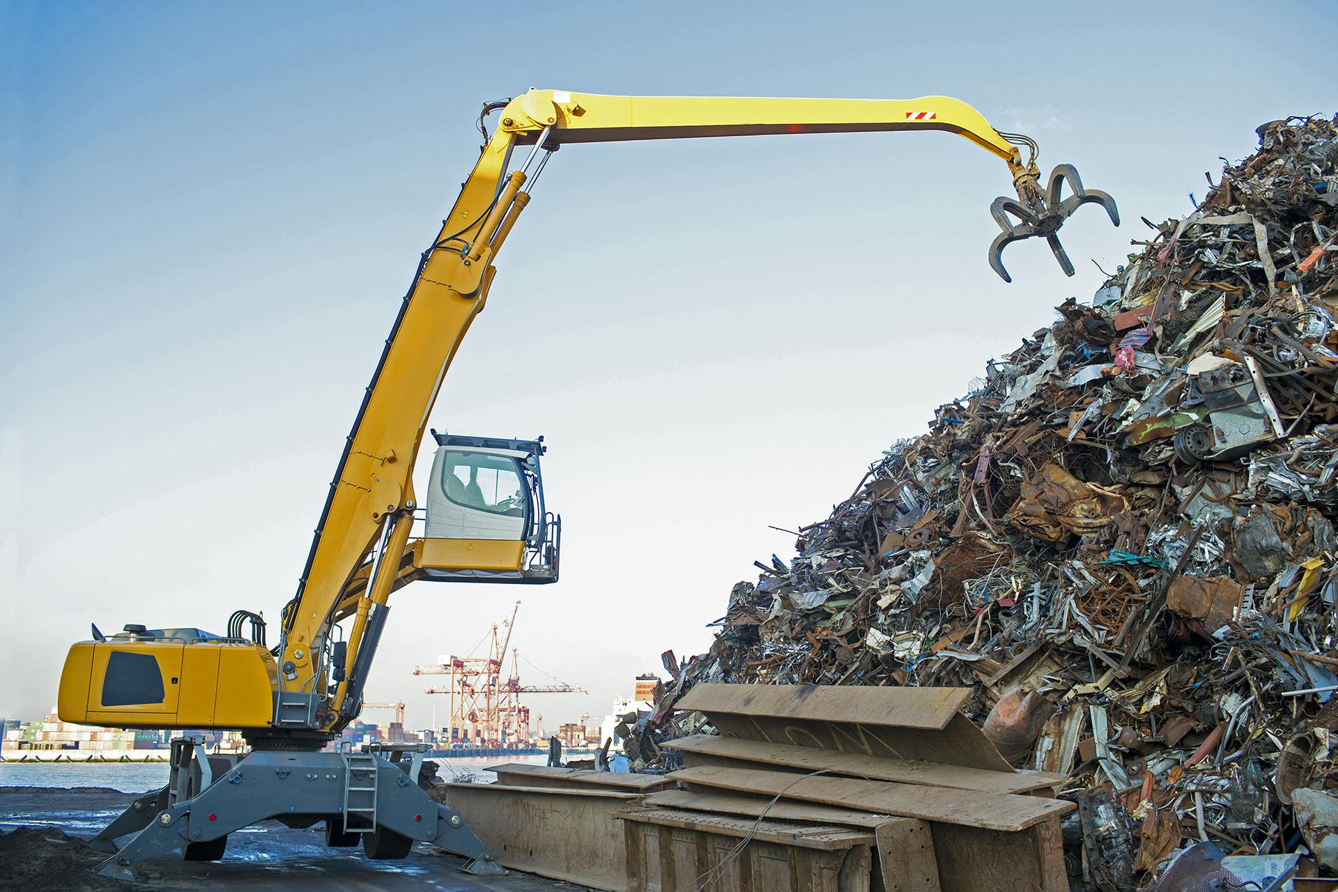 Image of a yellow dredger on a junkyard