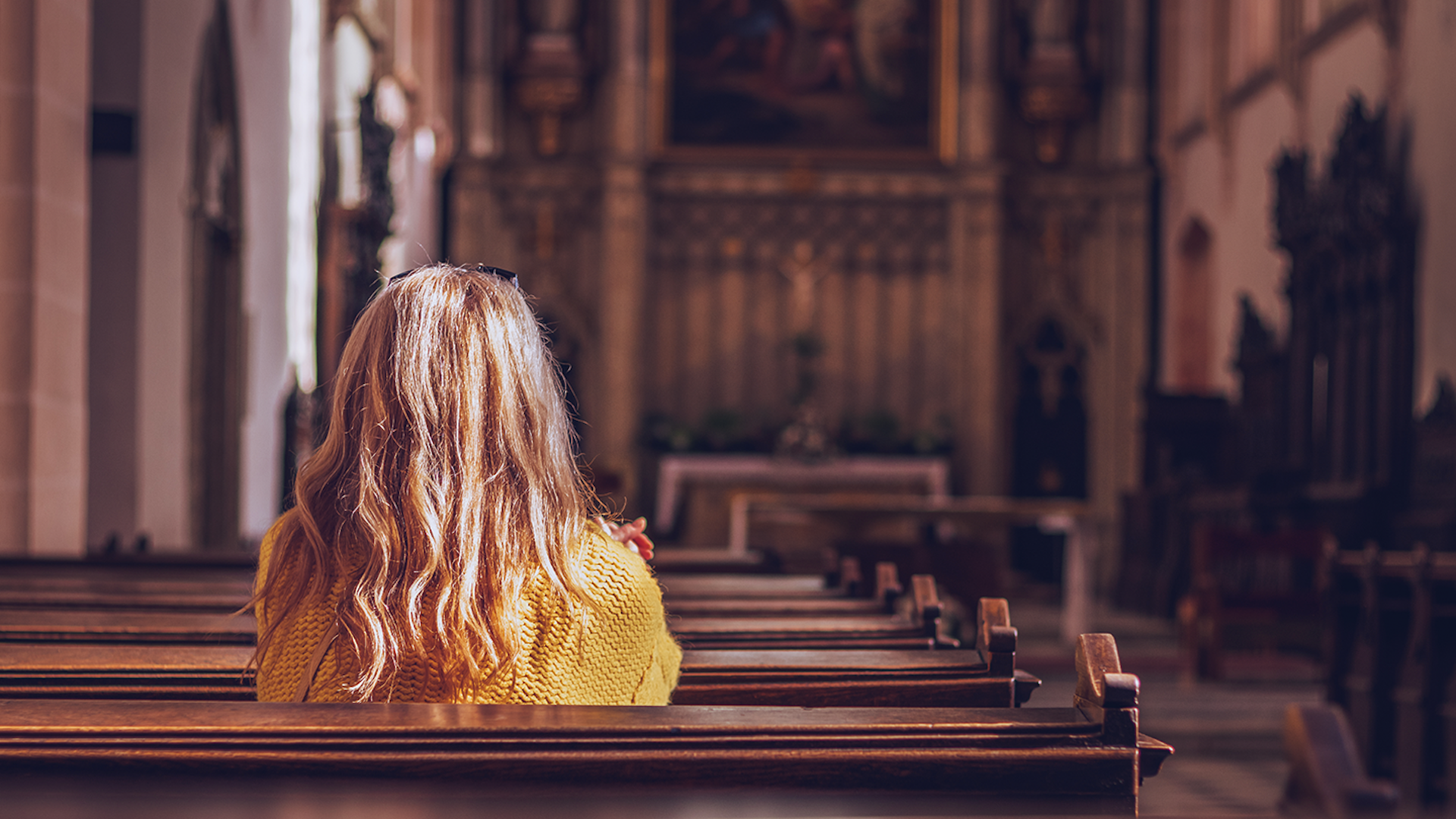 Photo of a woman sitting in church