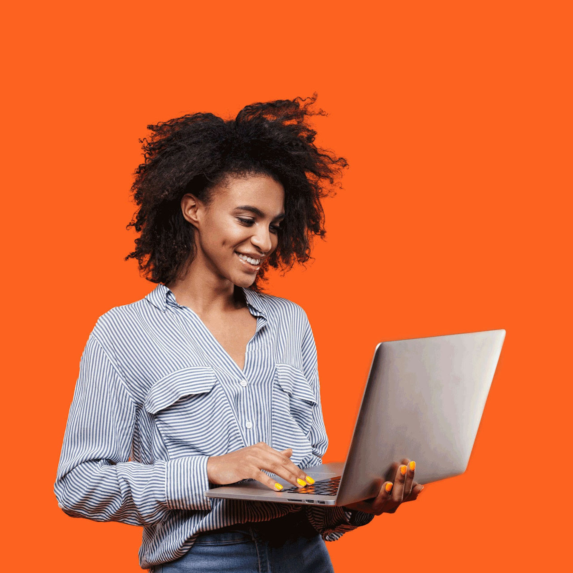 woman with her laptop standing in front of an orange background