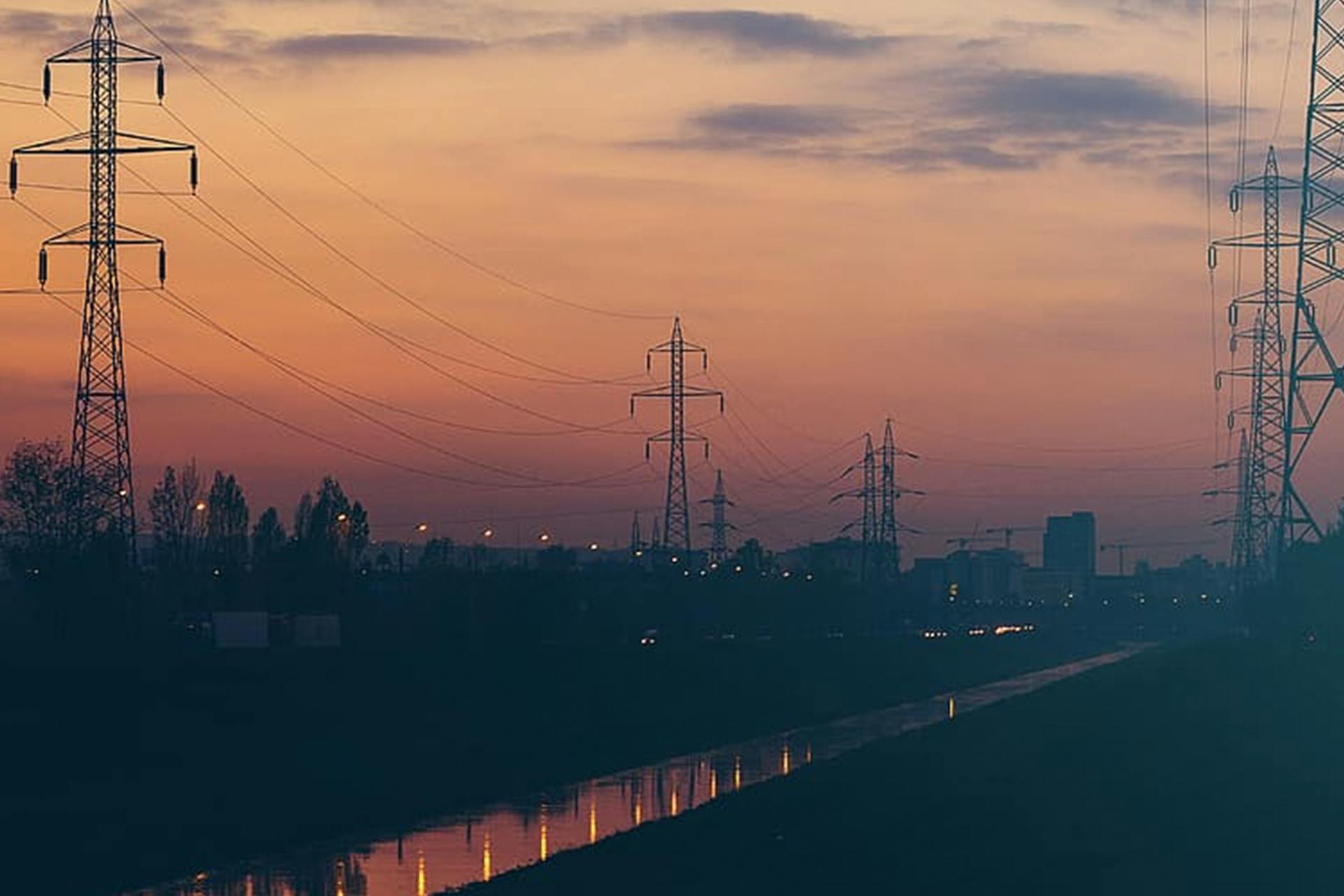 Photo of power masts in the sunset
