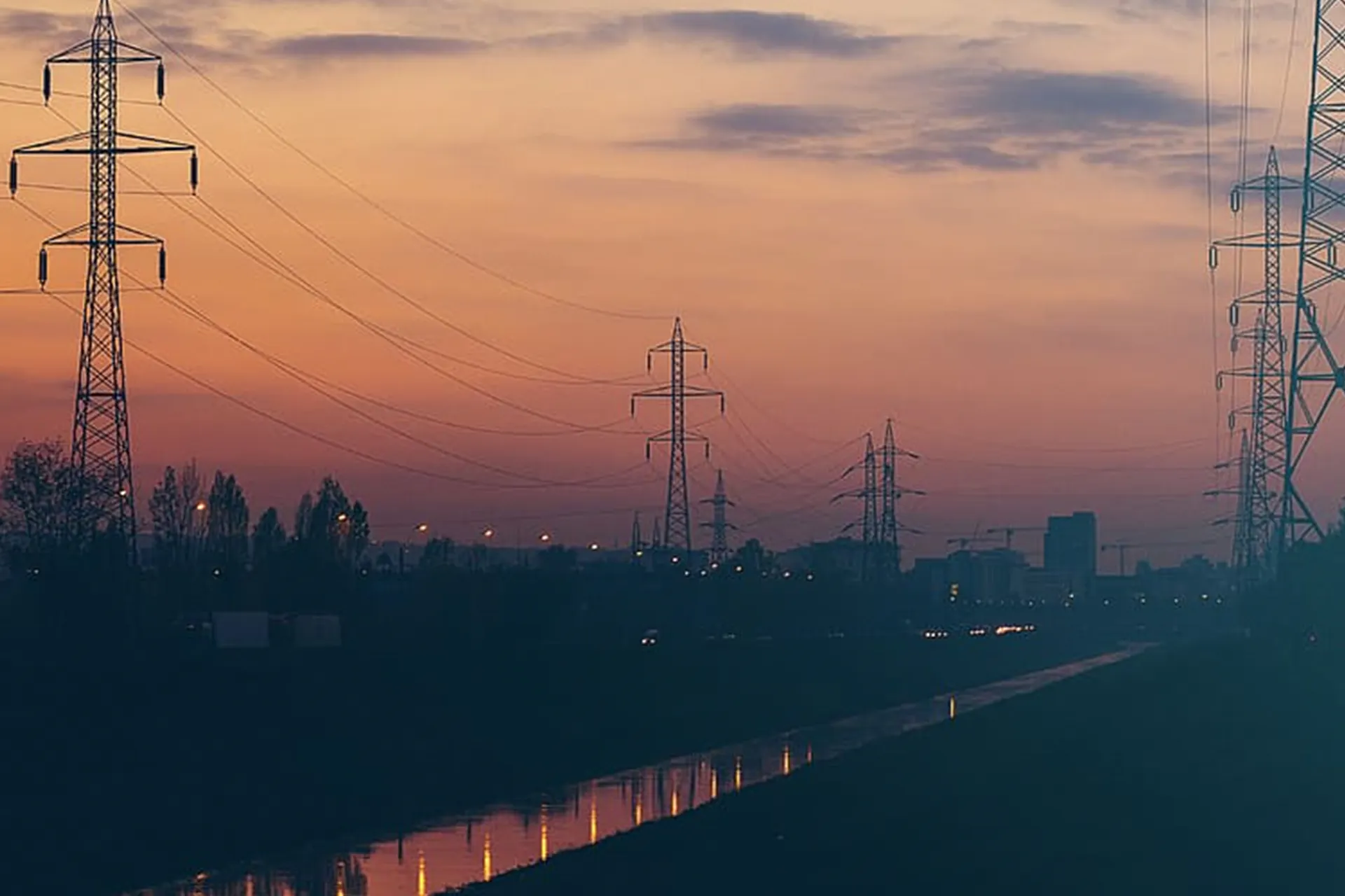 Photo of power masts in the sunset