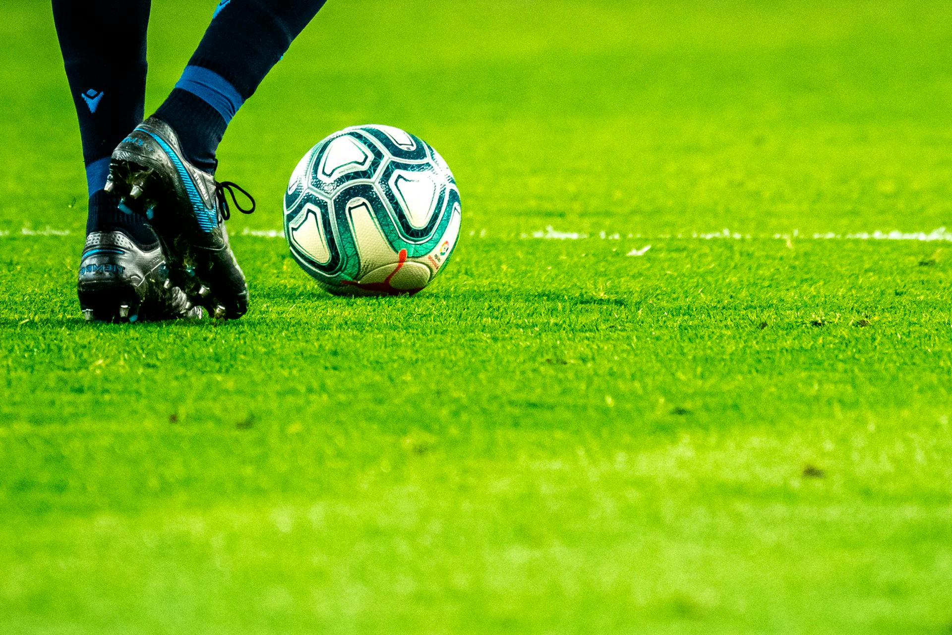 Photo of a football player about to kick a football