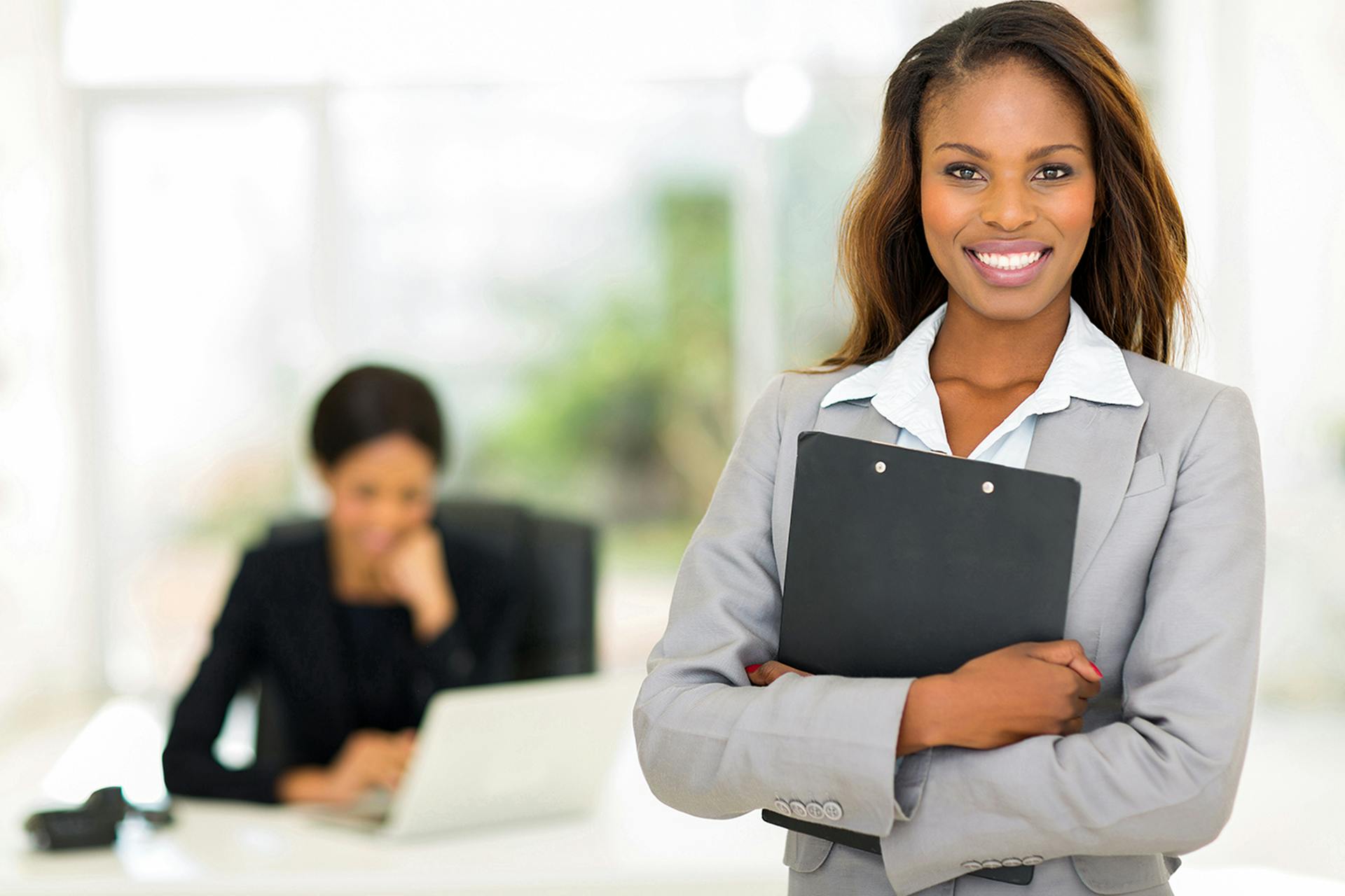 photo of a young woman with a clipboard in her hand in the office
