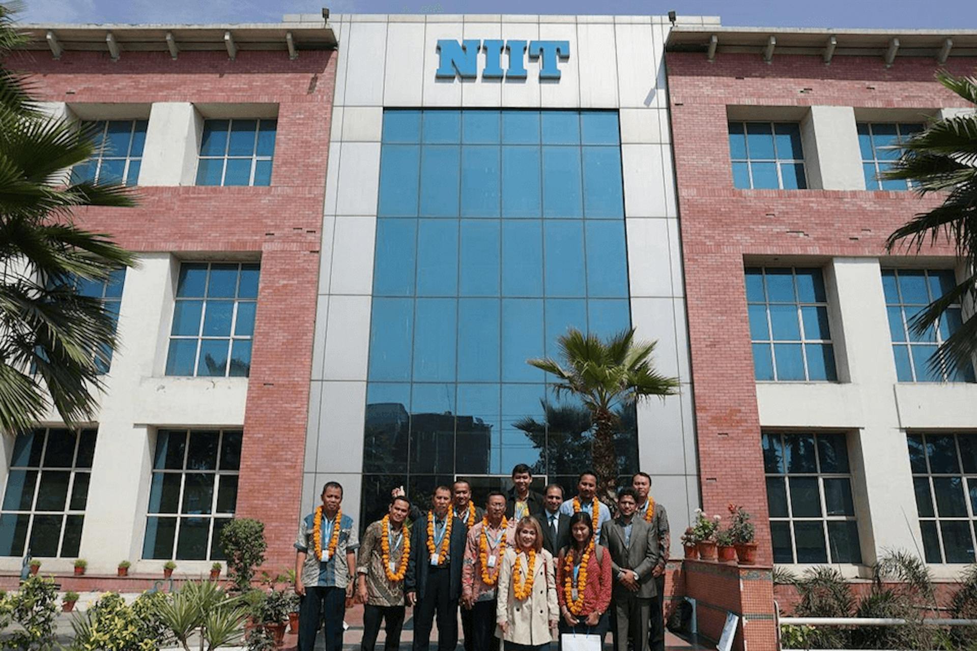 Photo of a NIIT building with staff members
