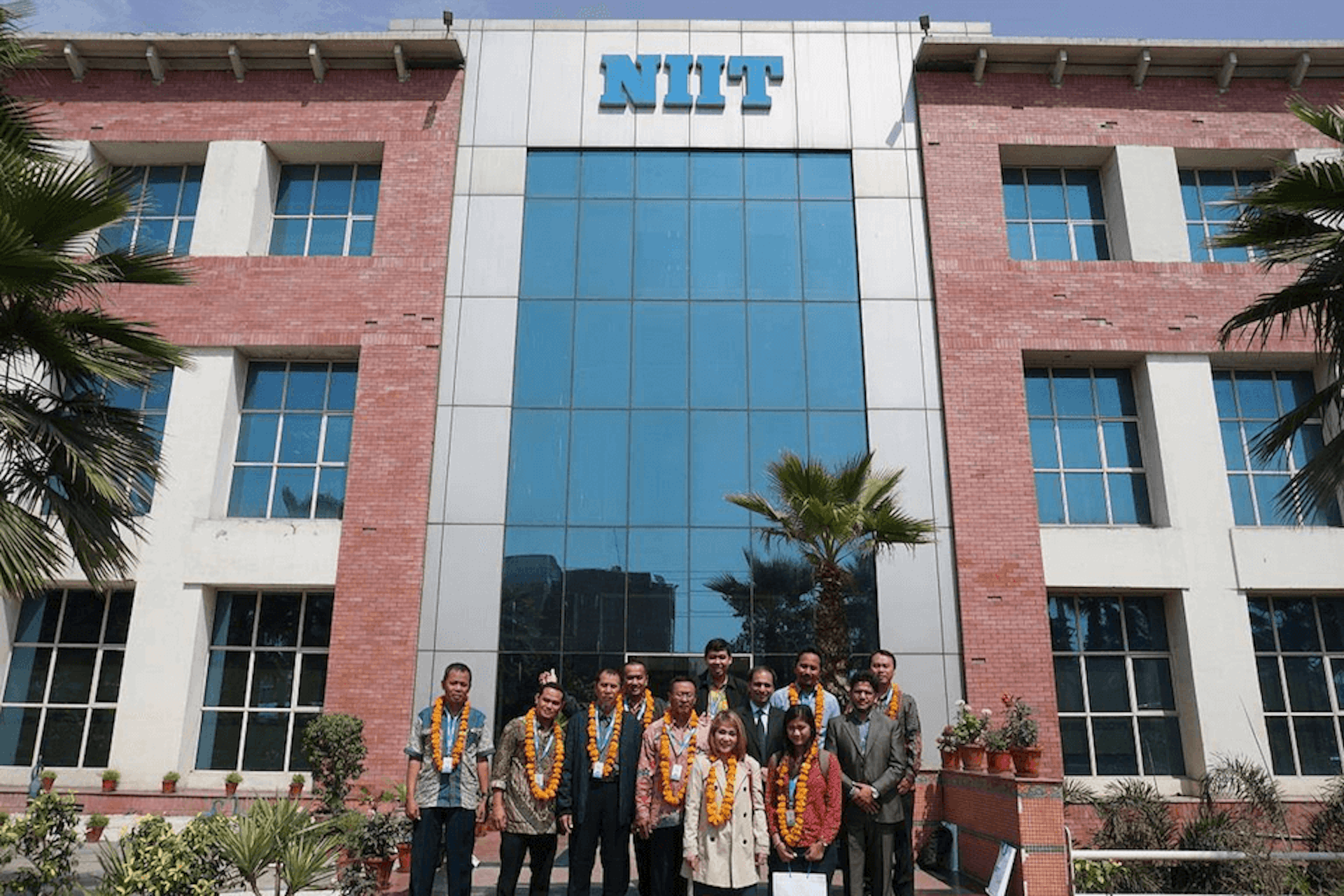 Photo of a NIIT building with staff members