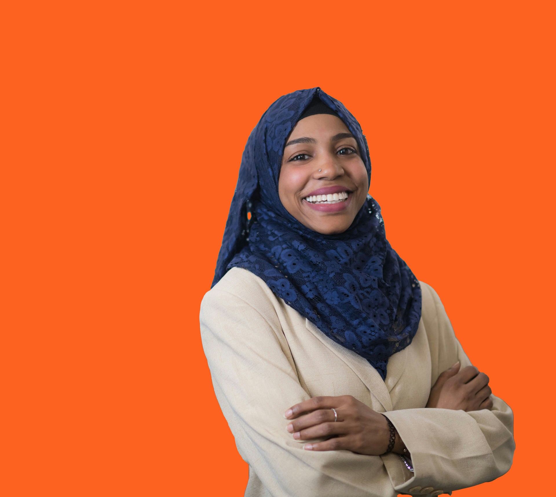 a woman standing in front of an orange background