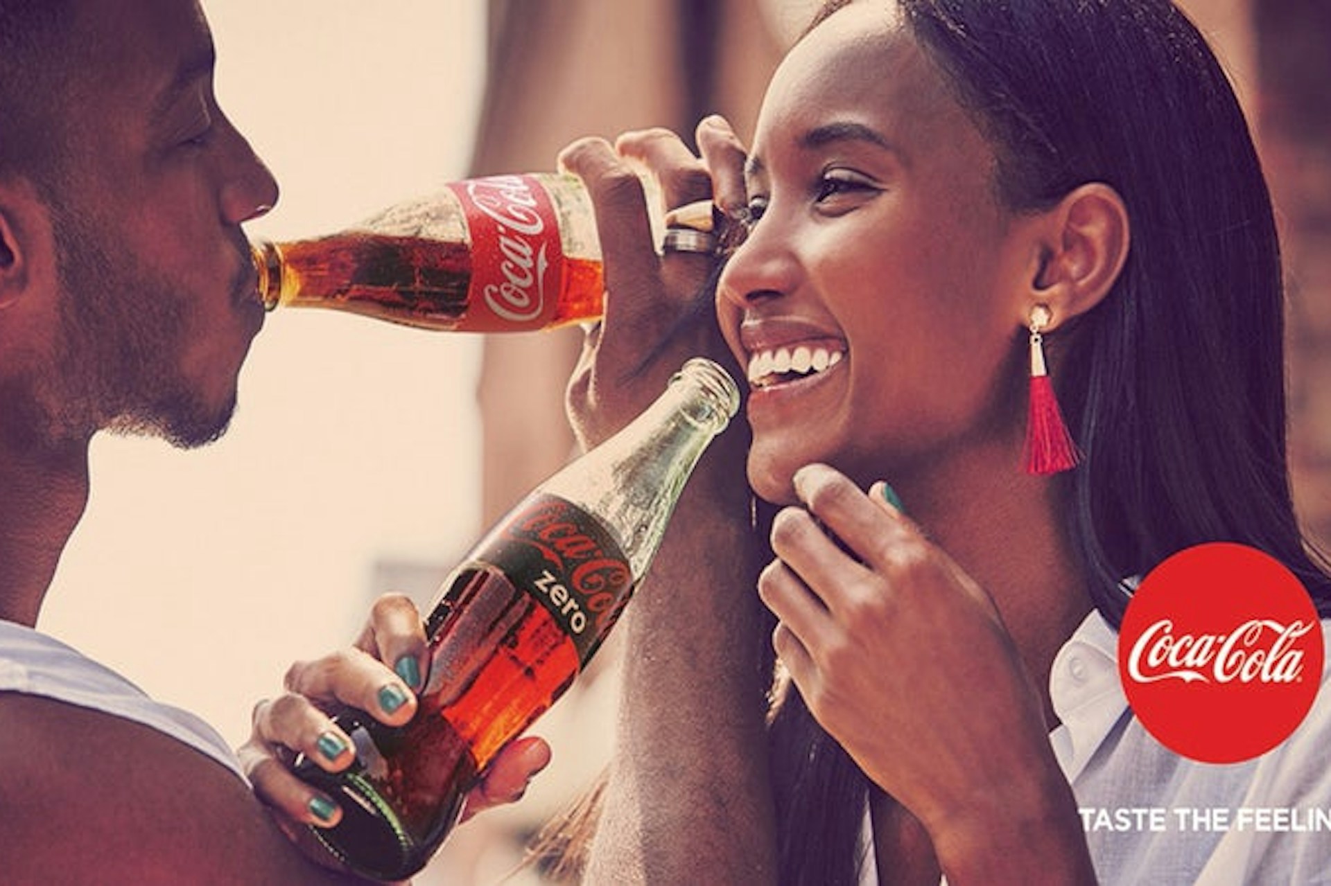 A man and a woman drinking coca cola 