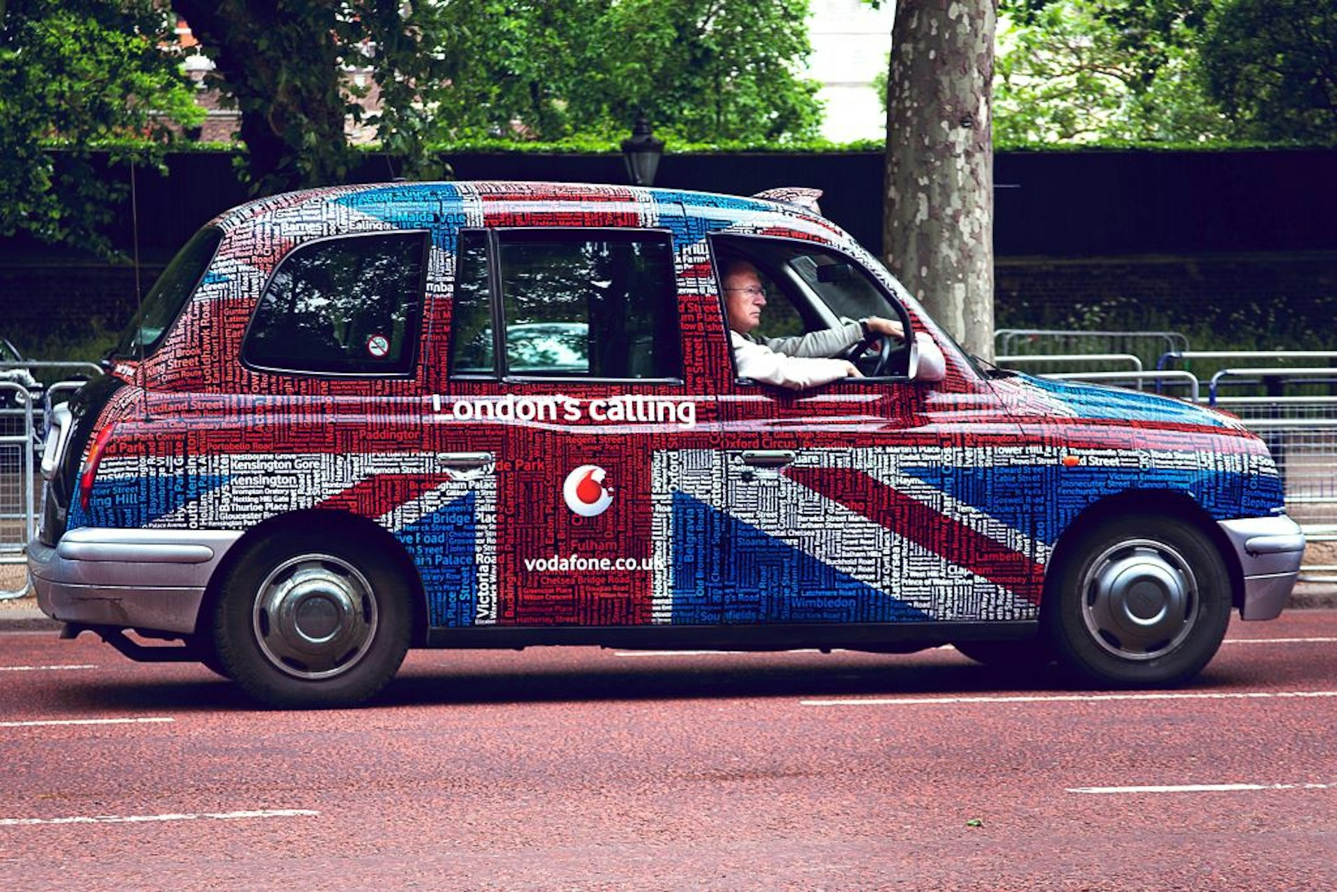 A London taxi cab painted with the British flag.
