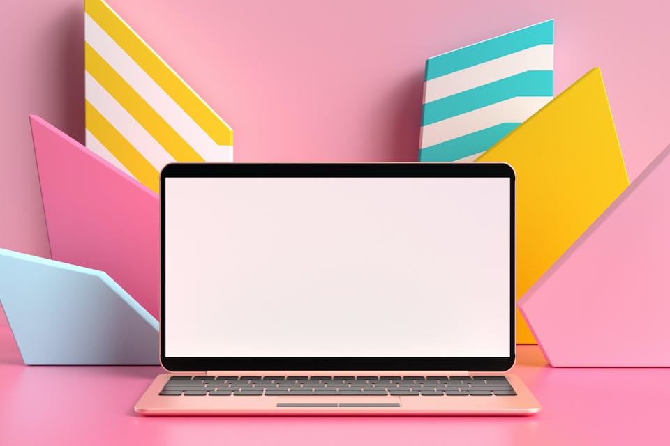 Image of a laptop in front of a pink and colorful background