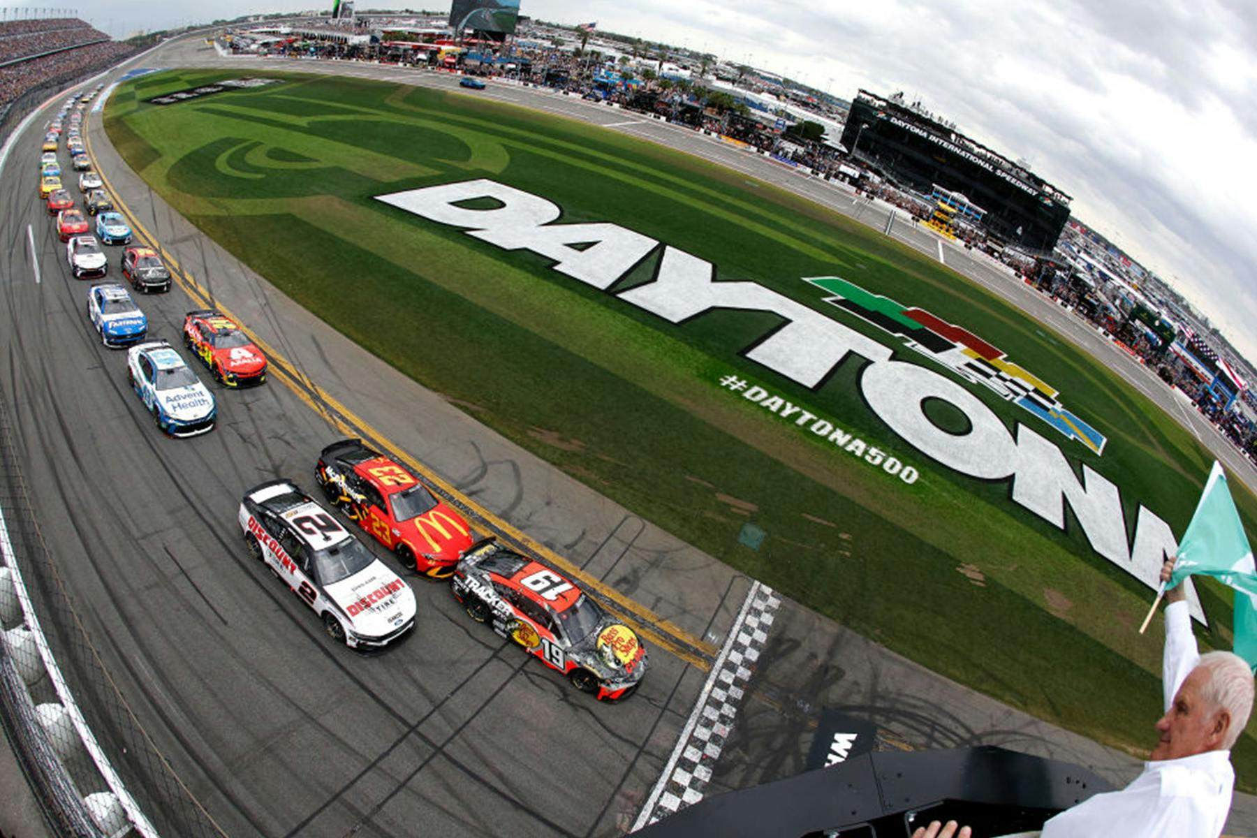 A fish eye lens photo of stock cars racing in the Daytona 500.