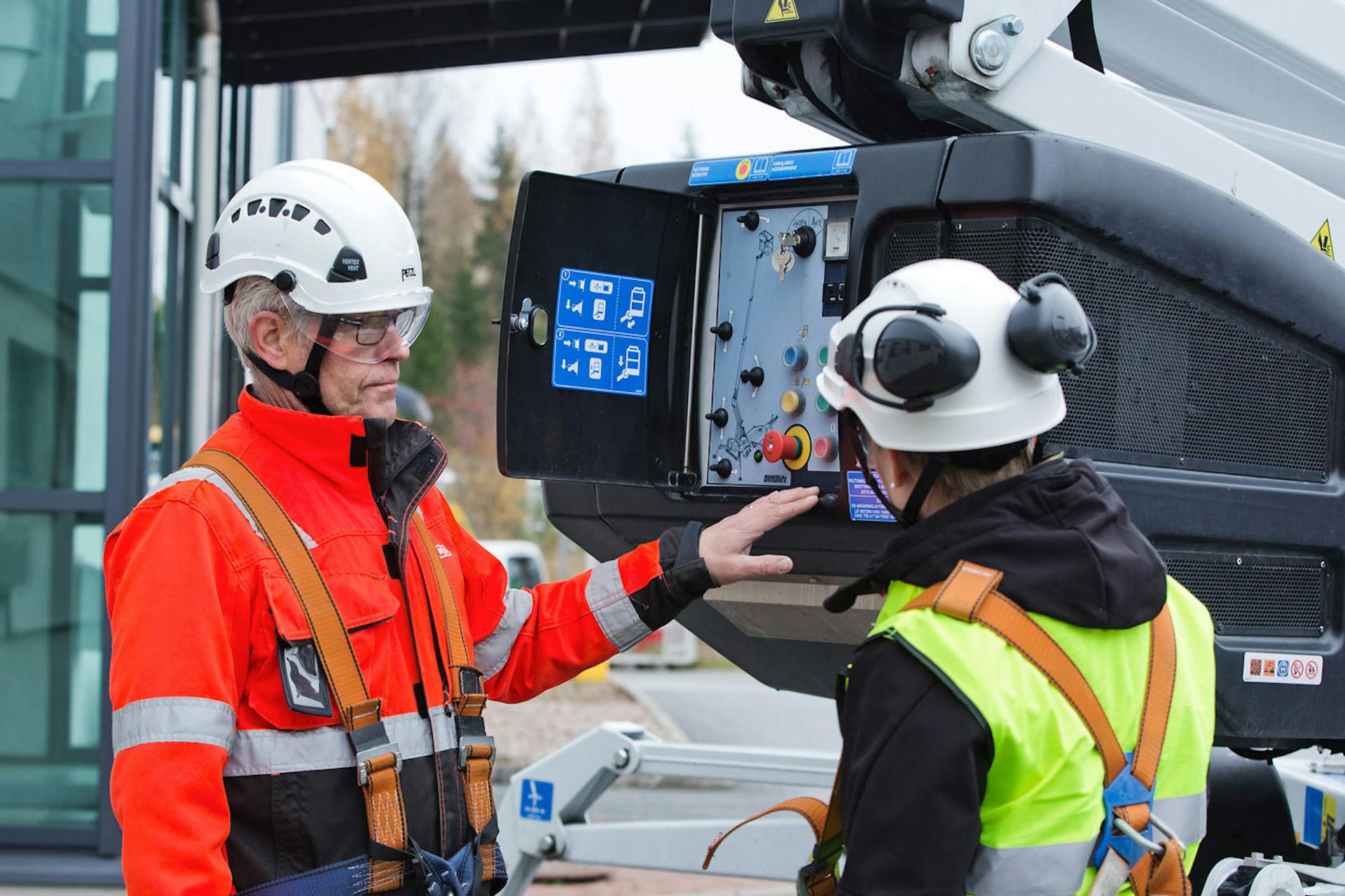 Photo of two people in warn jackets working