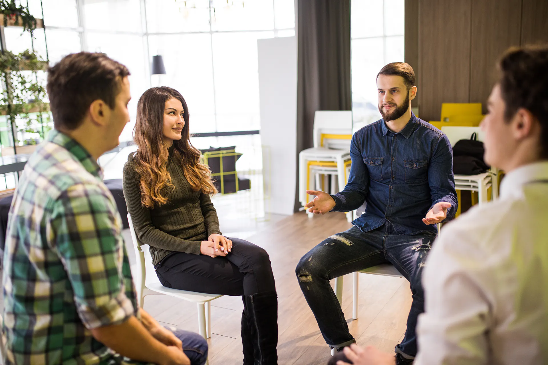 Photo of people sitting on chairs in a circle