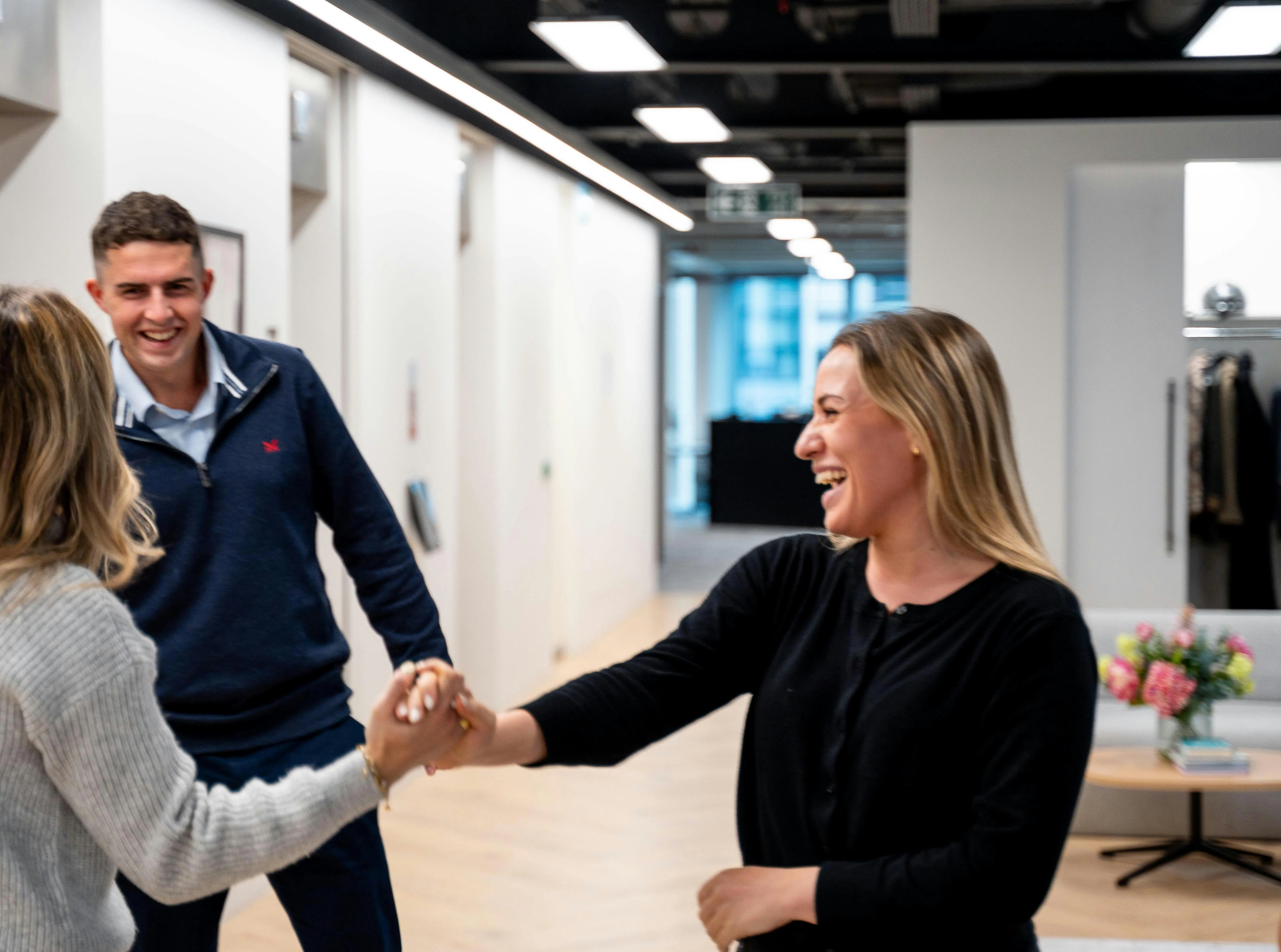 Colleagues in an office laughing together