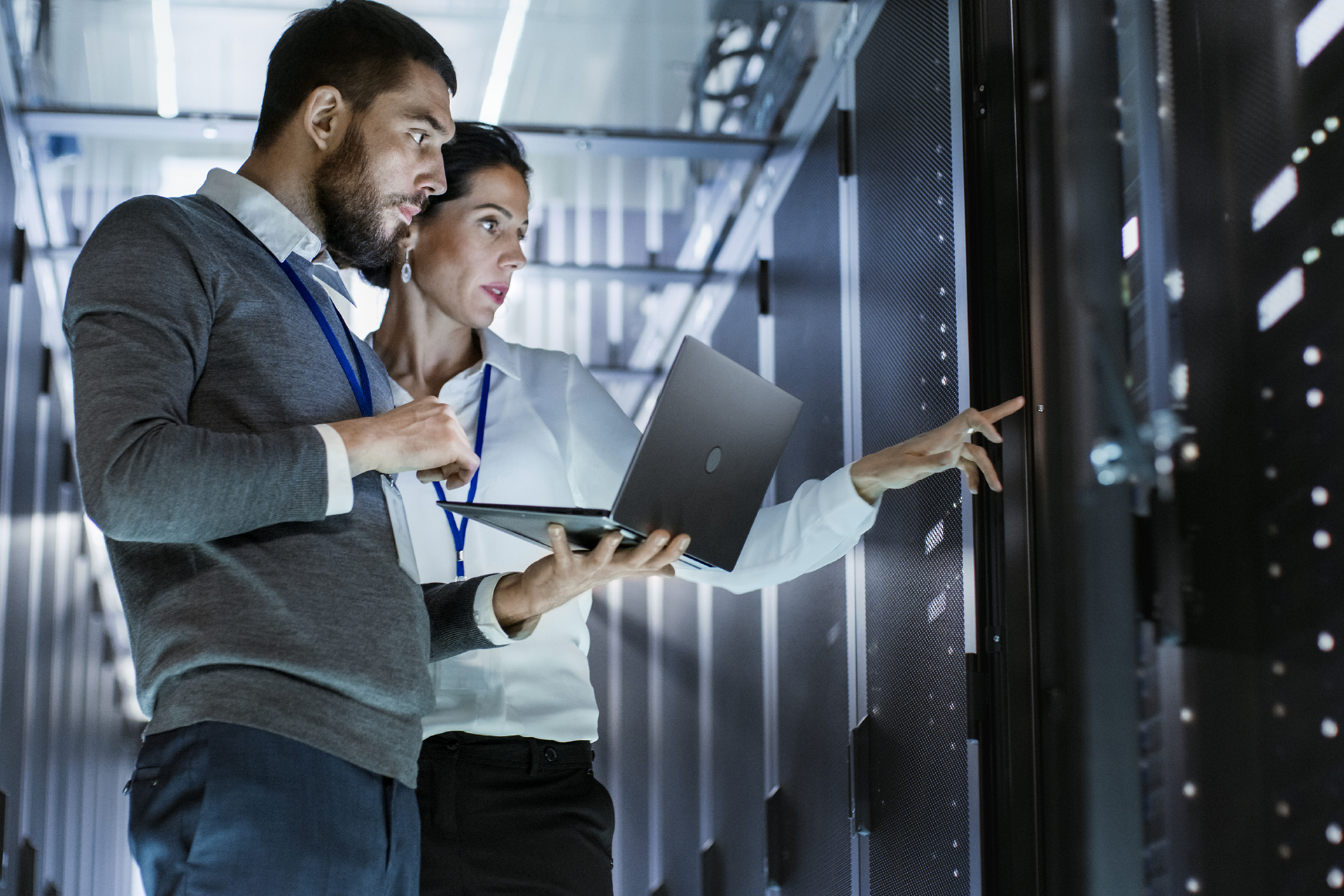 Photo of a man and a woman working in a server room