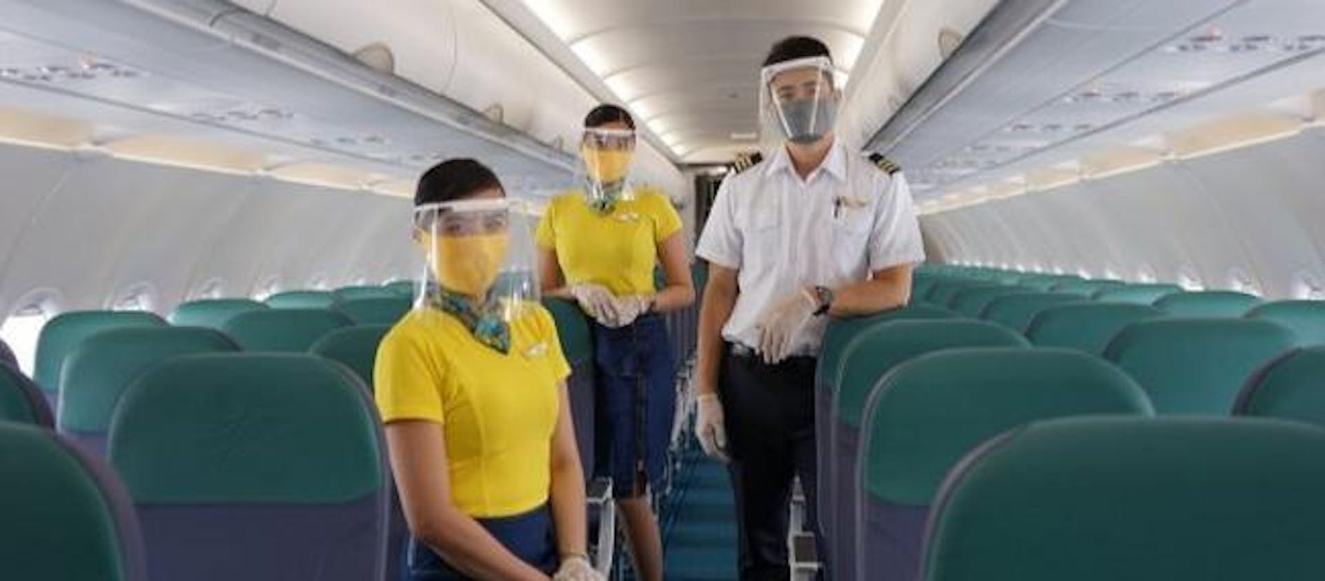 Photo of the Cebu Pacific crew with masks on board of a plane