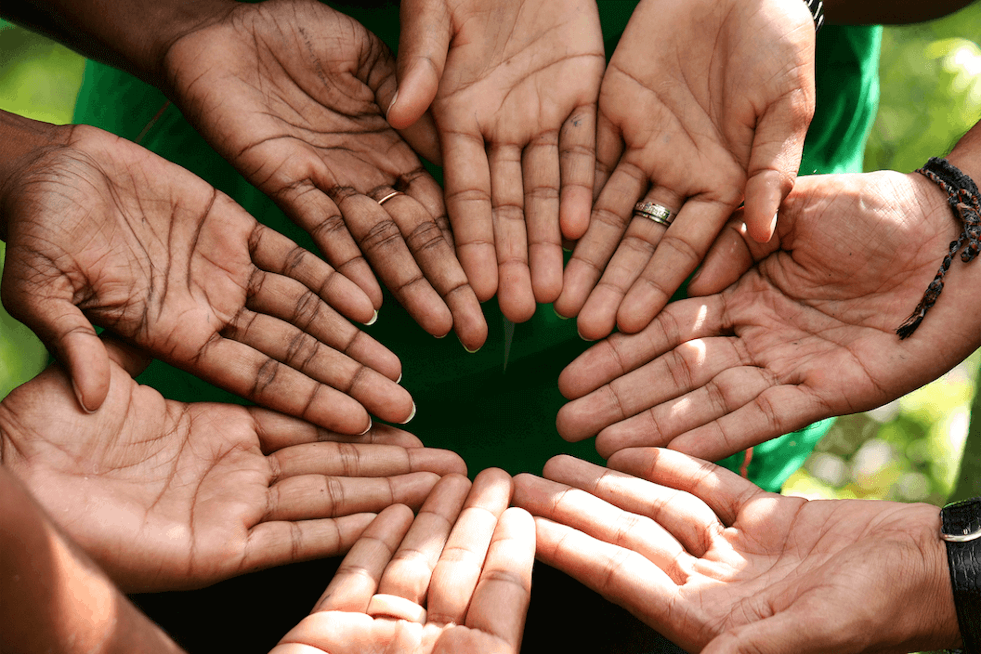 Photo of hands together in a circle, palms facing the sky