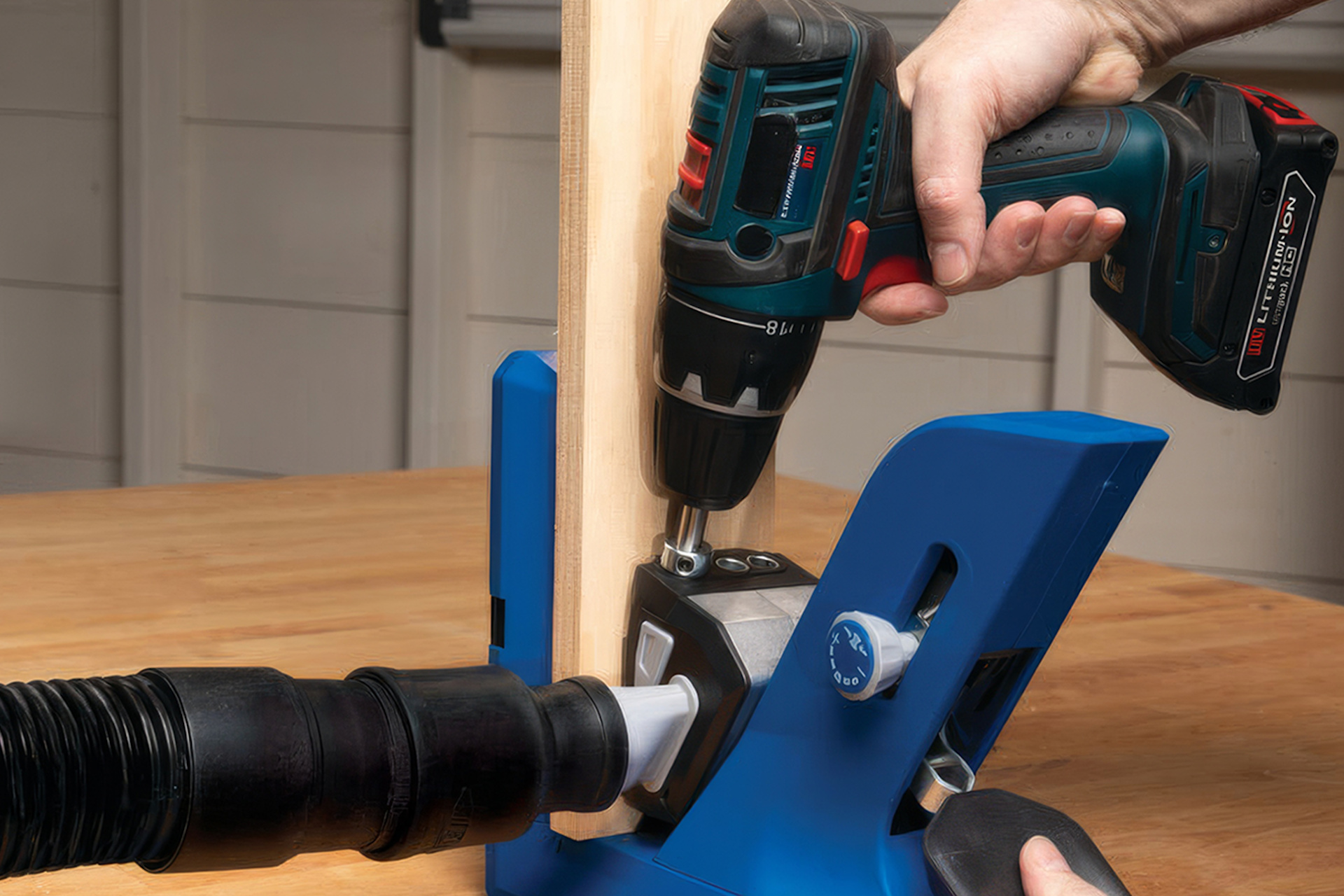 Hands hold a drill against a slat of wood in a blue securing device in this image for a Meltwater customer story about the Kreg Tool Company.