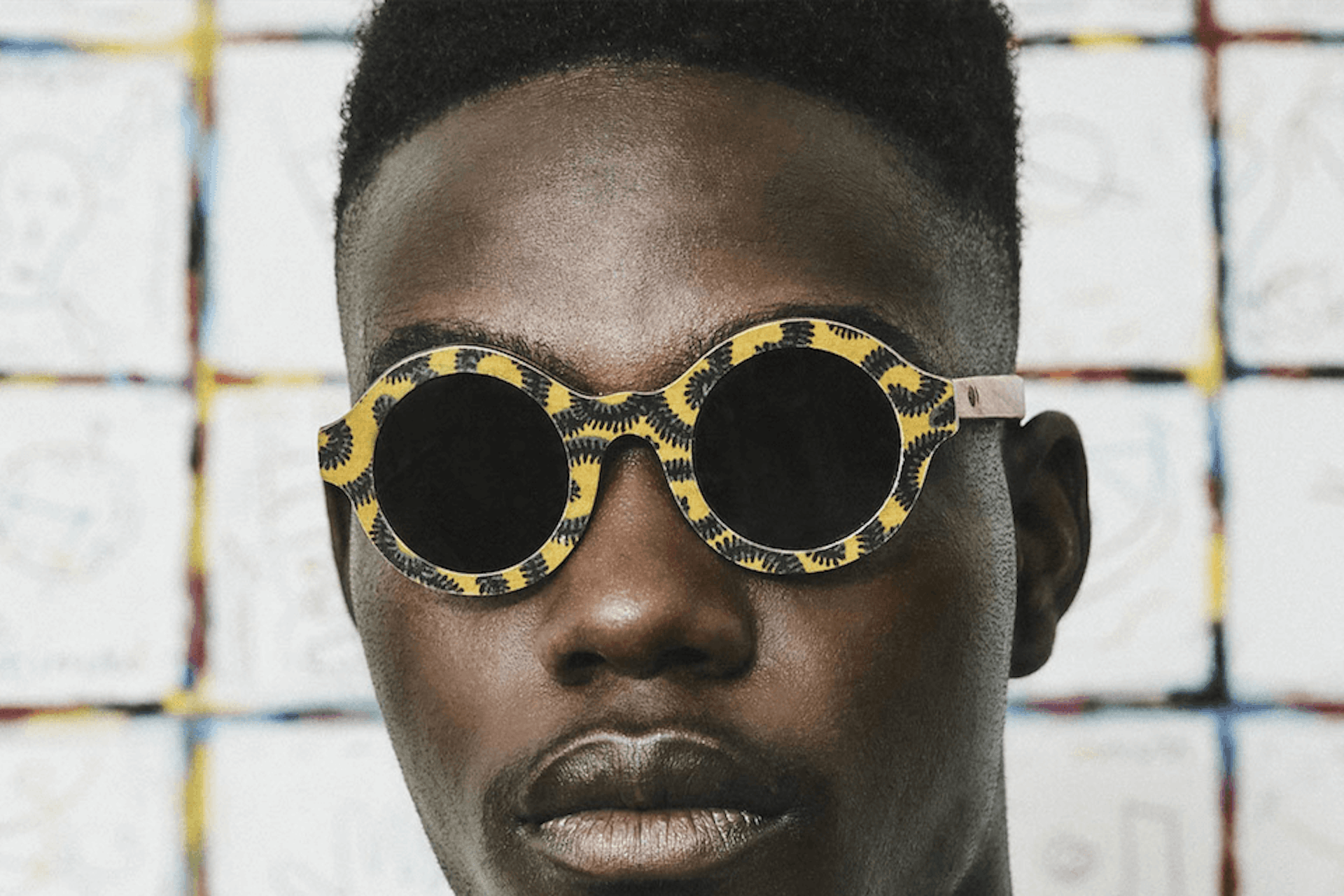 Photo of a young man with a yellow sunglasses
