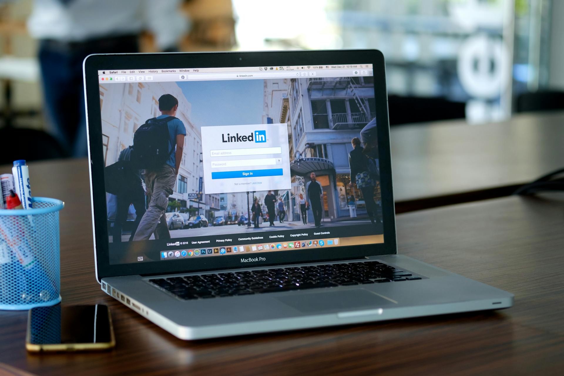 A laptop on a desk with the LinkedIn homepage open