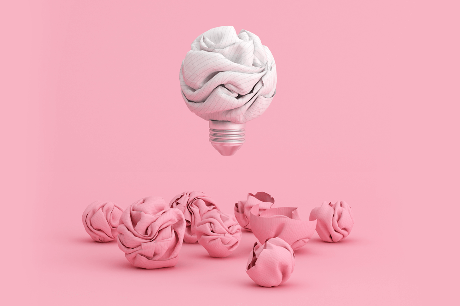Illustration of a lightbulb as a crumpled sheet of white paper floating above several crumpled pieces of pink paper. Ideas for content creation blog post