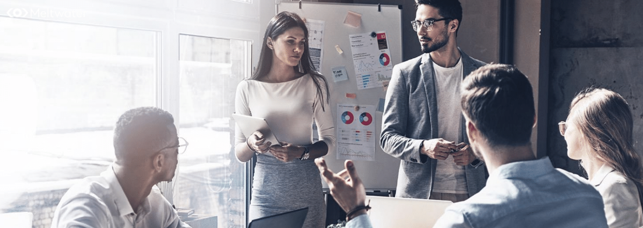 People gathered in an office having a meeting.