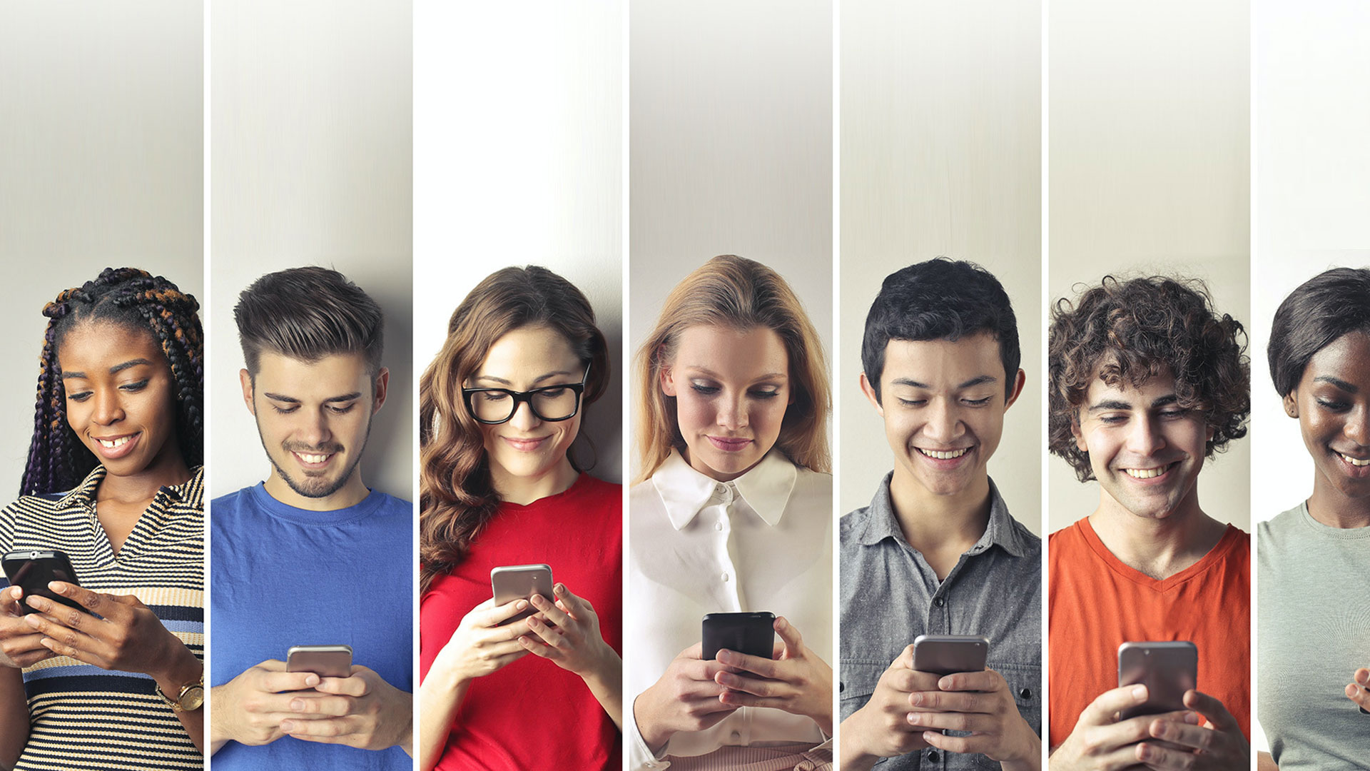 Photo of different people next to each other with their smartphones in hand