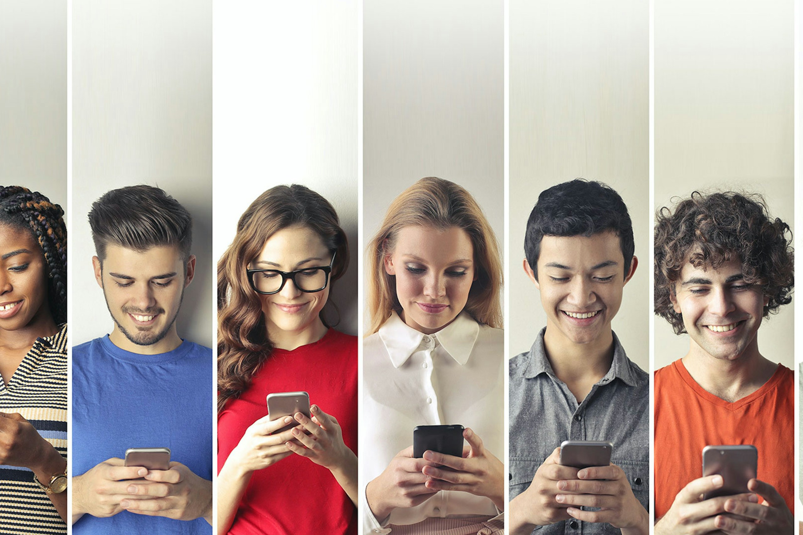 Photo of different people next to each other with their smartphones in hand