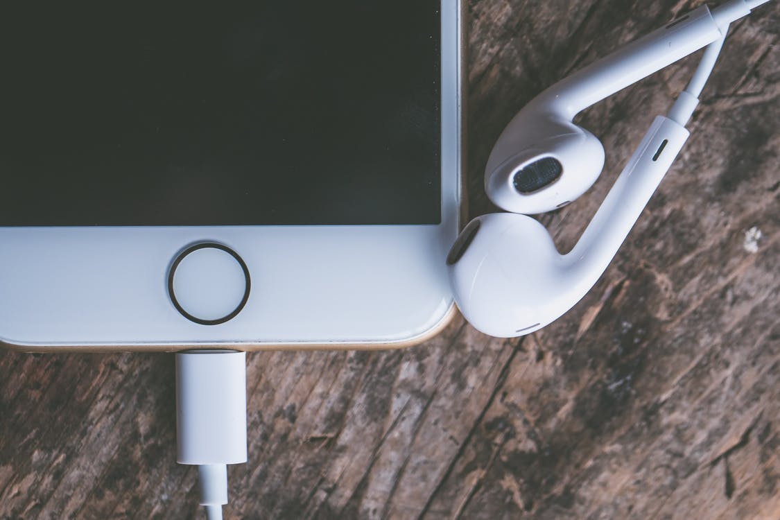 Smartphone with Headphones on wooden table iPhone
