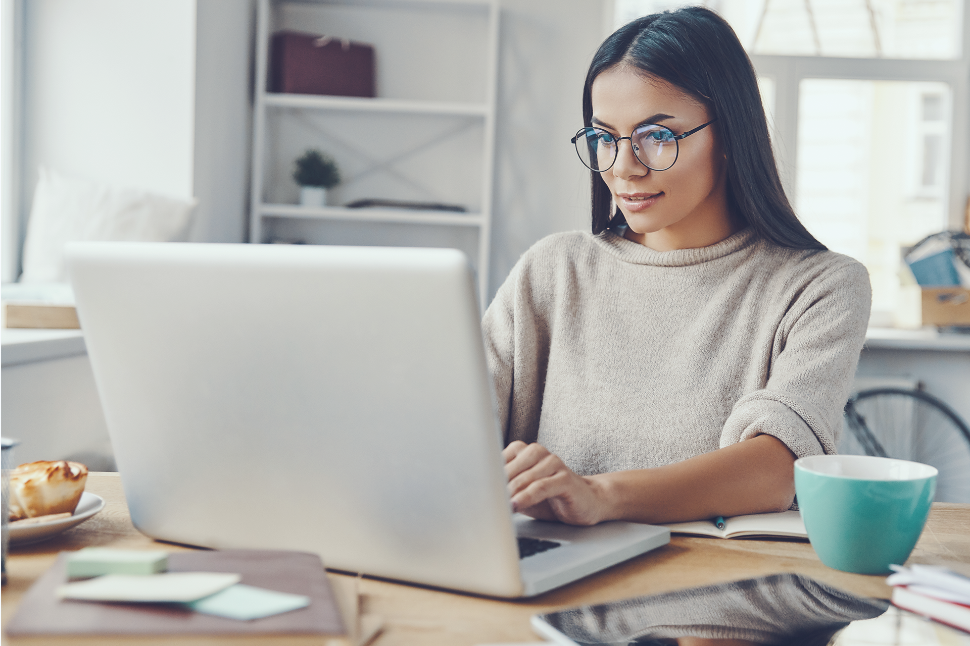 photo of a woman sitting in front of her laptop