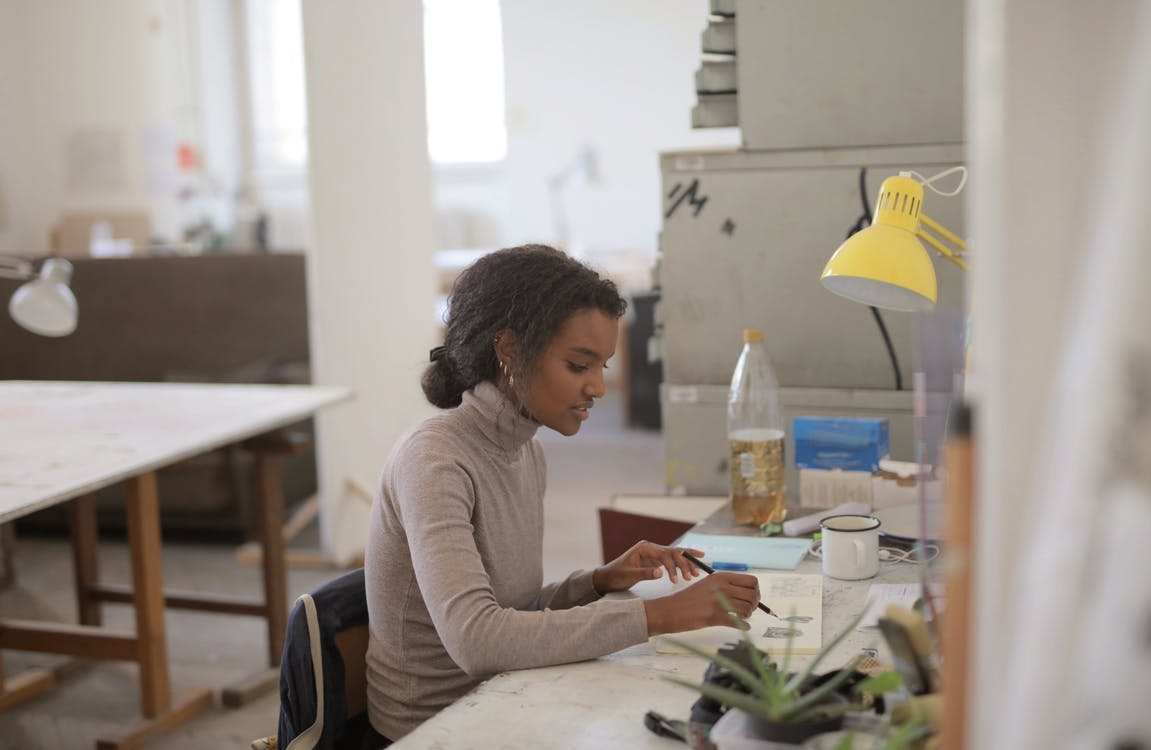 woman sitting on desk learning