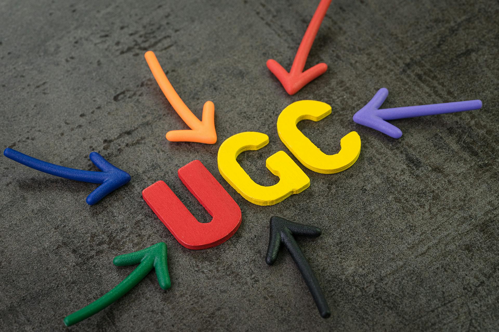 Letters UGC in red and blue with arrows pointing to it