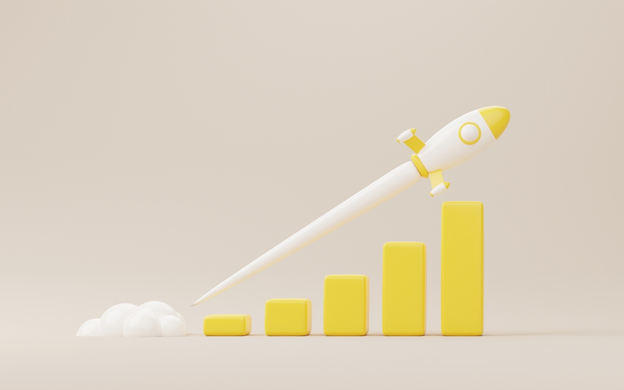 An illustration of a rocket shooting upwards across a bar chart. 