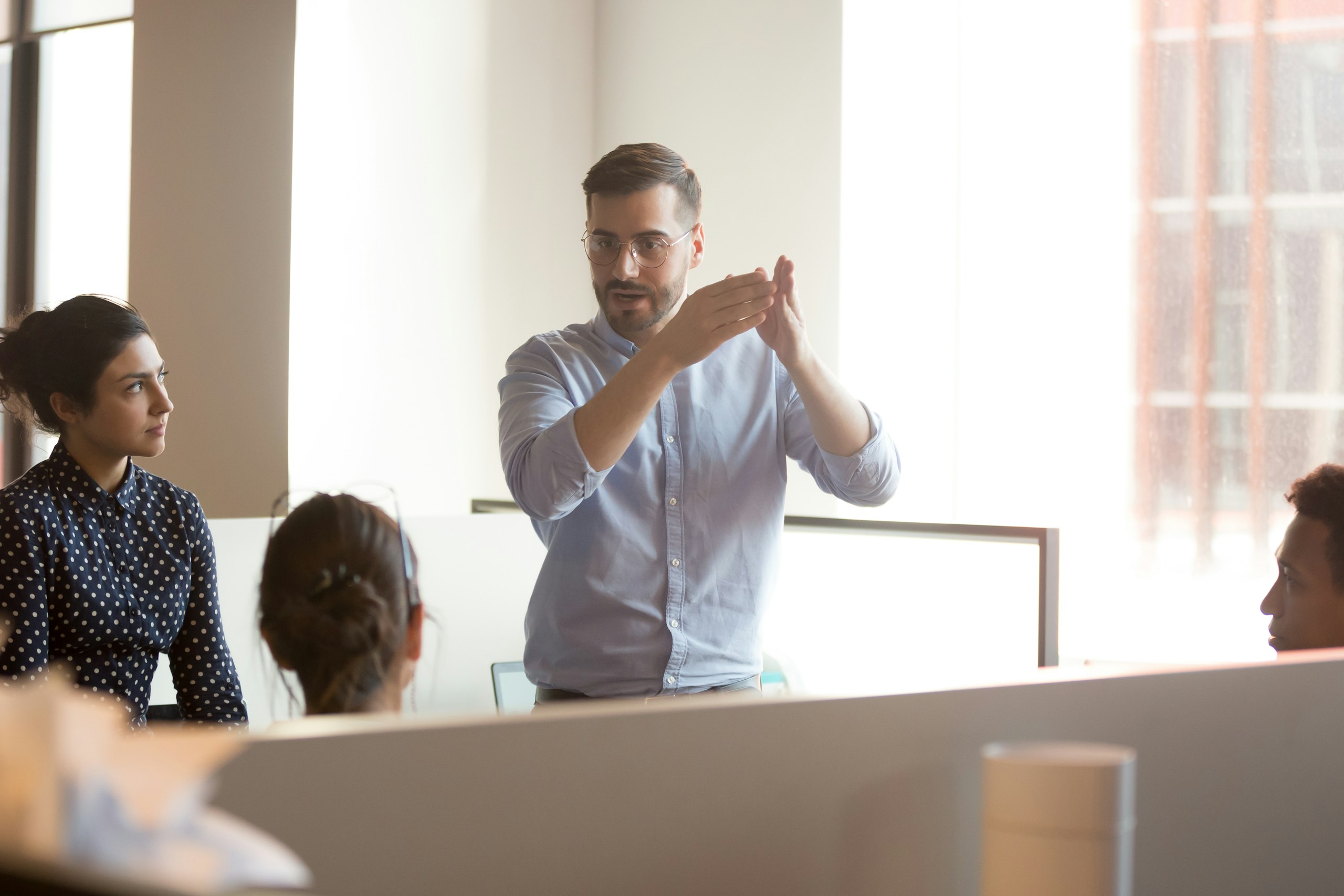 A team leader demonstrating a concept to his team using gestures