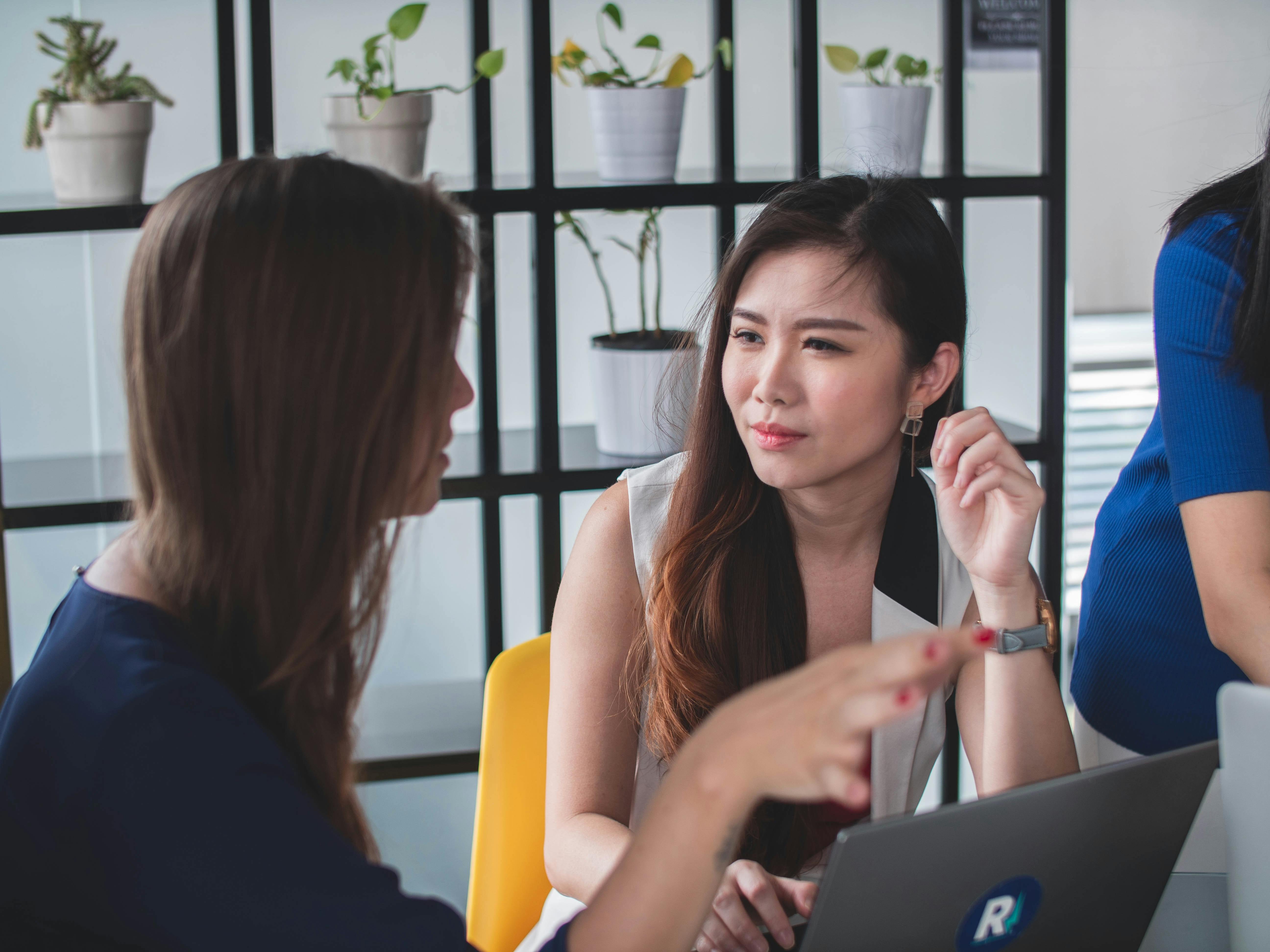 woman looking at another woman during a meeting