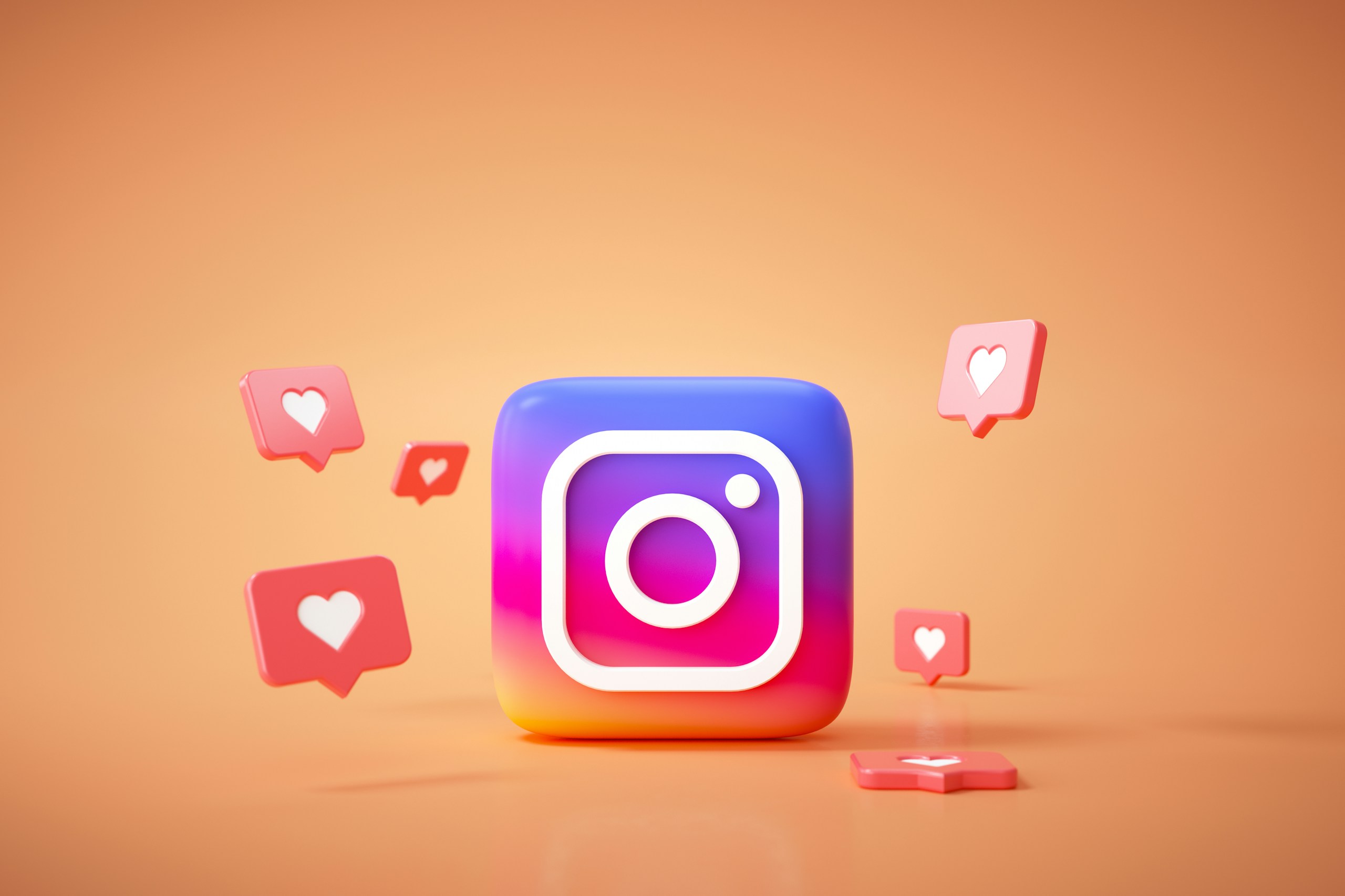 オレンジの背景にInstagramのロゴと、複数のハートが配置されている画像