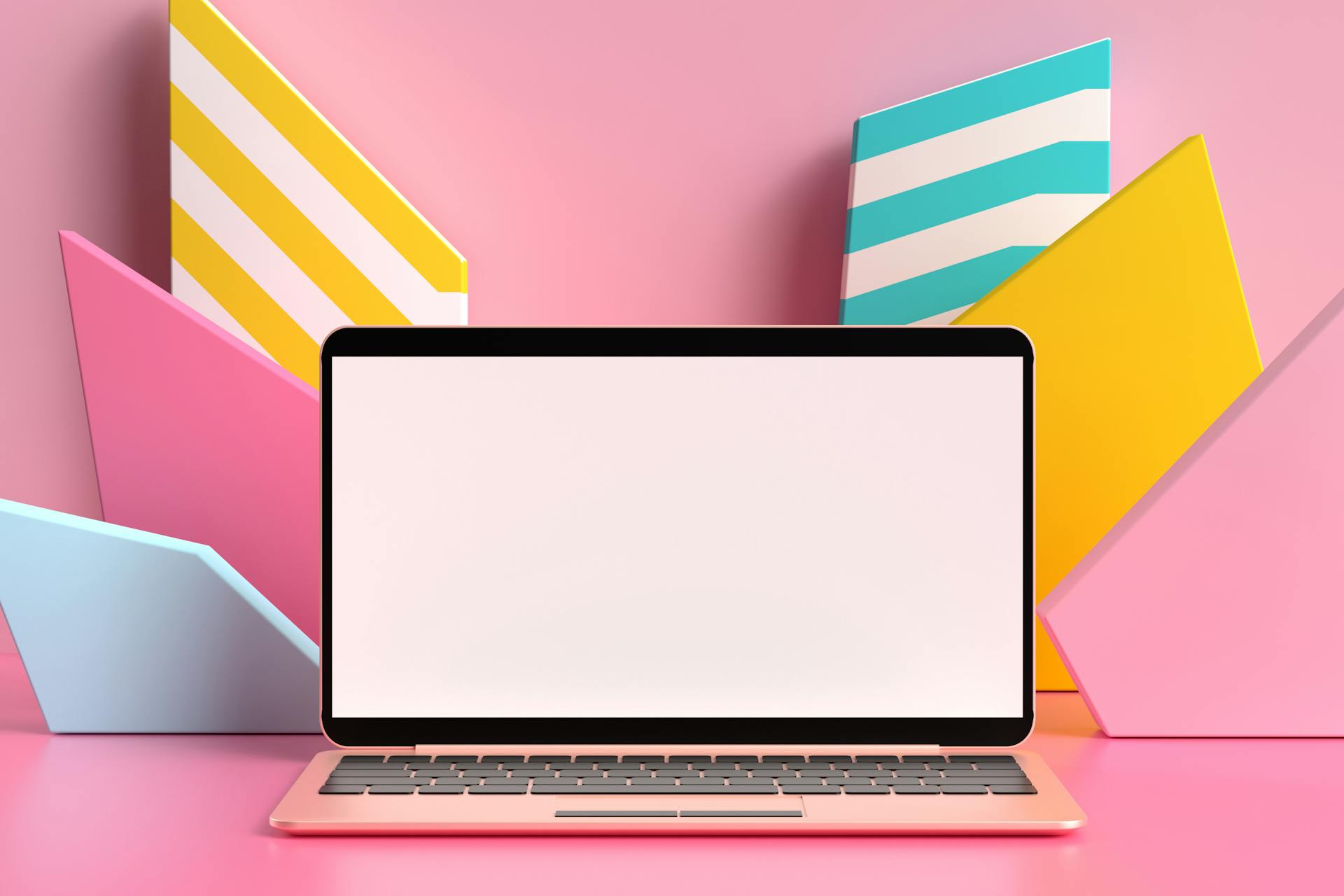 Foto eines Laptops vor einem pinken Hintergrund mit bunten 3D Formen. Der Laptop Bildschirm ist noch weiß als Metapher dafür, dass noch kein Branding Prozess erfolgt ist.