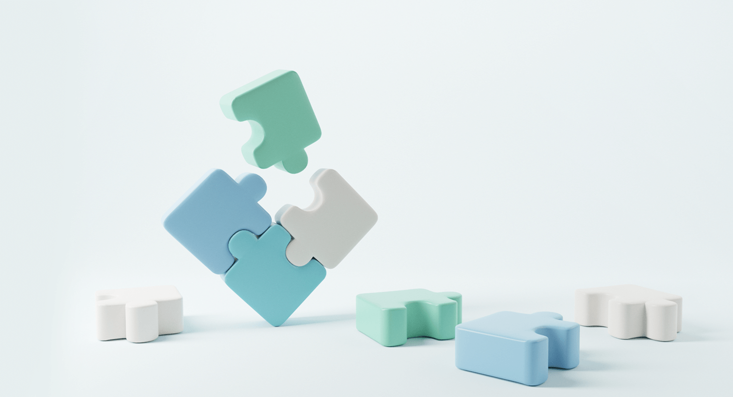 Illustration showing three puzzle pieces put together with a fourth puzzle piece about to be added to make a square. They are surrounded by other puzzle pieces on the ground. Essential roles on a modern marketing team blog post