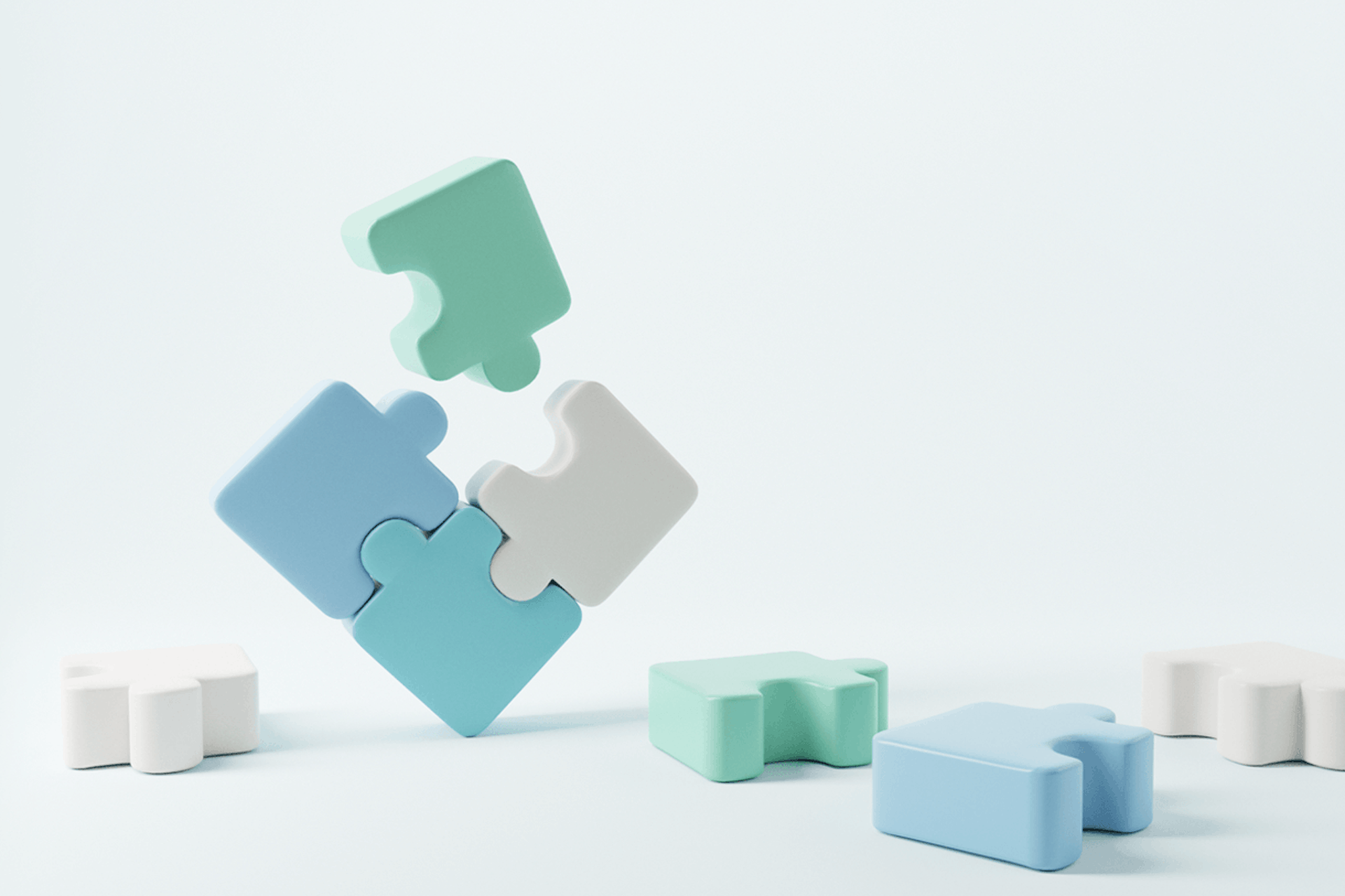 Illustration showing three puzzle pieces put together with a fourth puzzle piece about to be added to make a square. They are surrounded by other puzzle pieces on the ground. Essential roles on a modern marketing team blog post